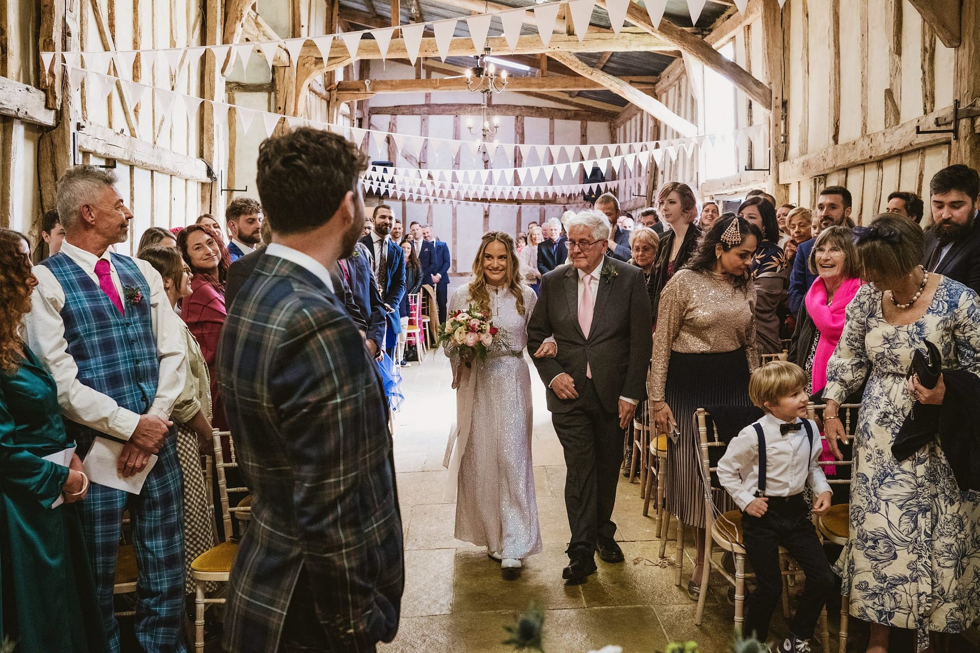 bride coming down the aisle at Alpheton Barns