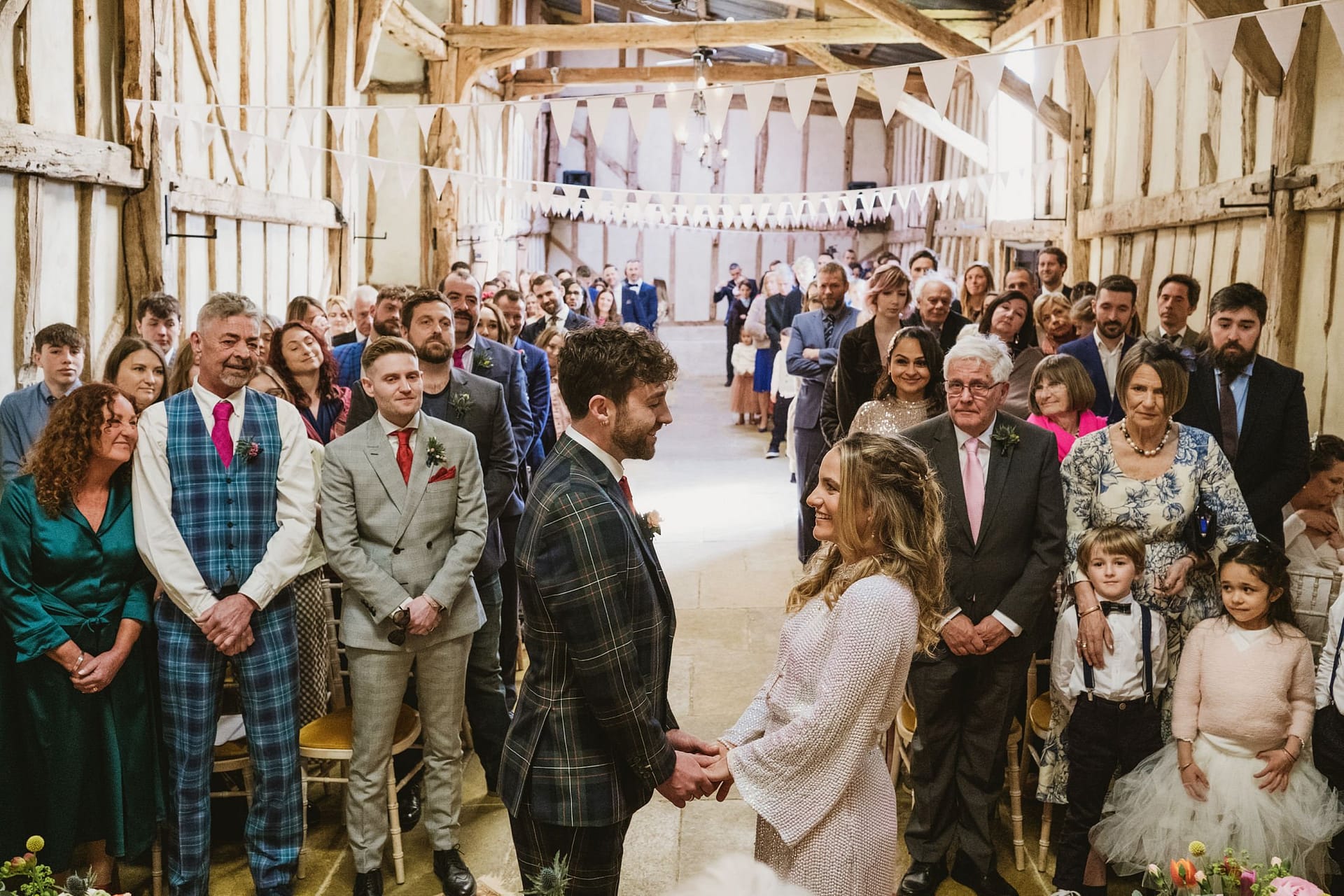 bride and groom exchanging vows at Alpheton Barns