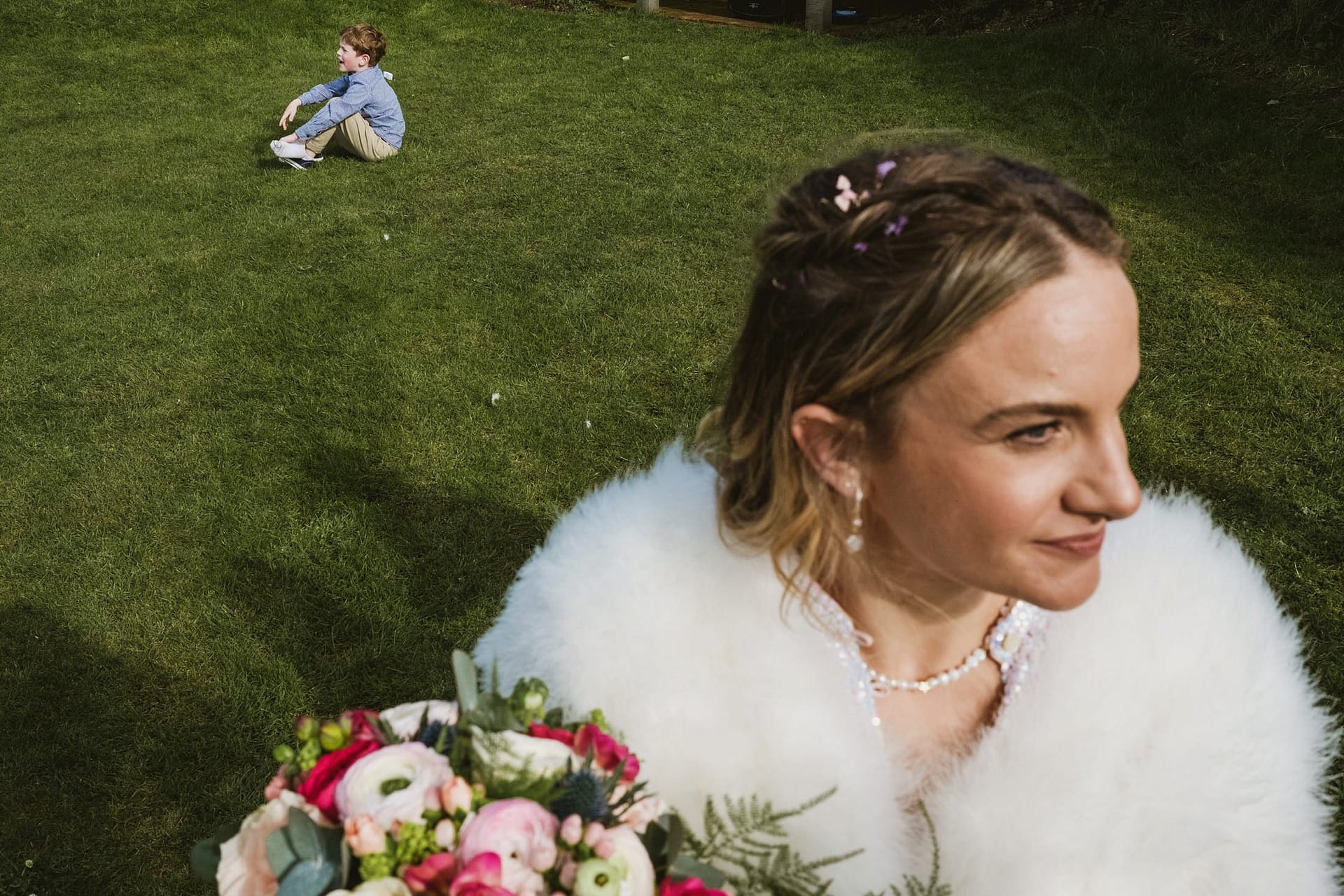 bride and little child in background at Alpheton Barns