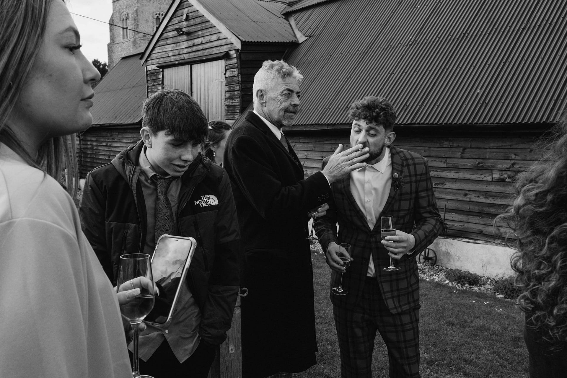 wedding guest giving someone a cigarette at Alpheton Barns suffolk