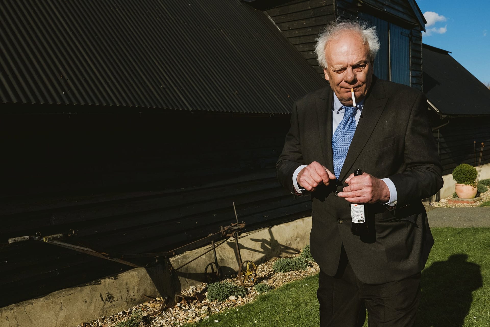 Alpheton Barns wedding guest, elderly gentleman smoking looking at camera