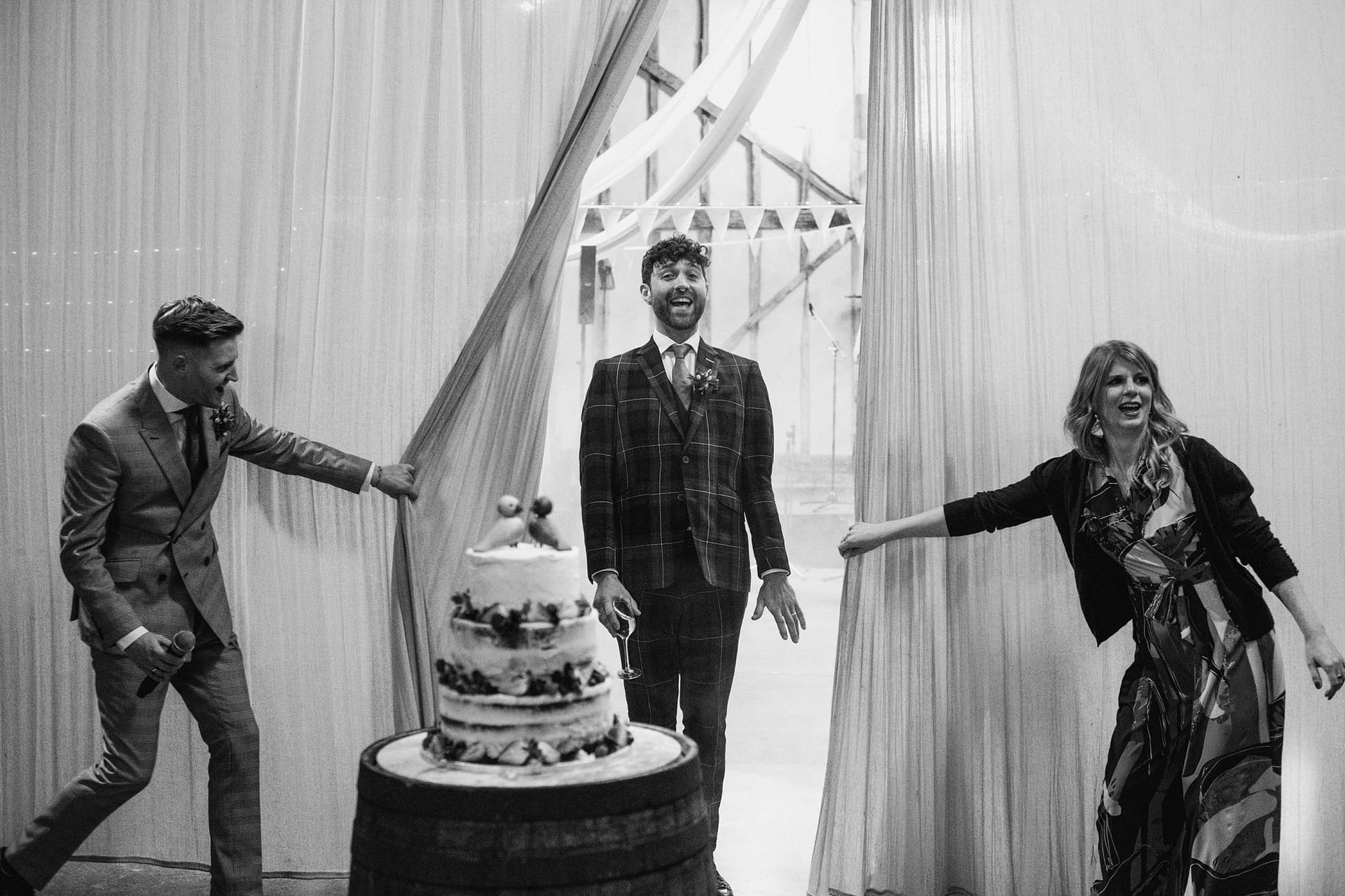 bride and groom being revealed by curtain at Alpheton Barns