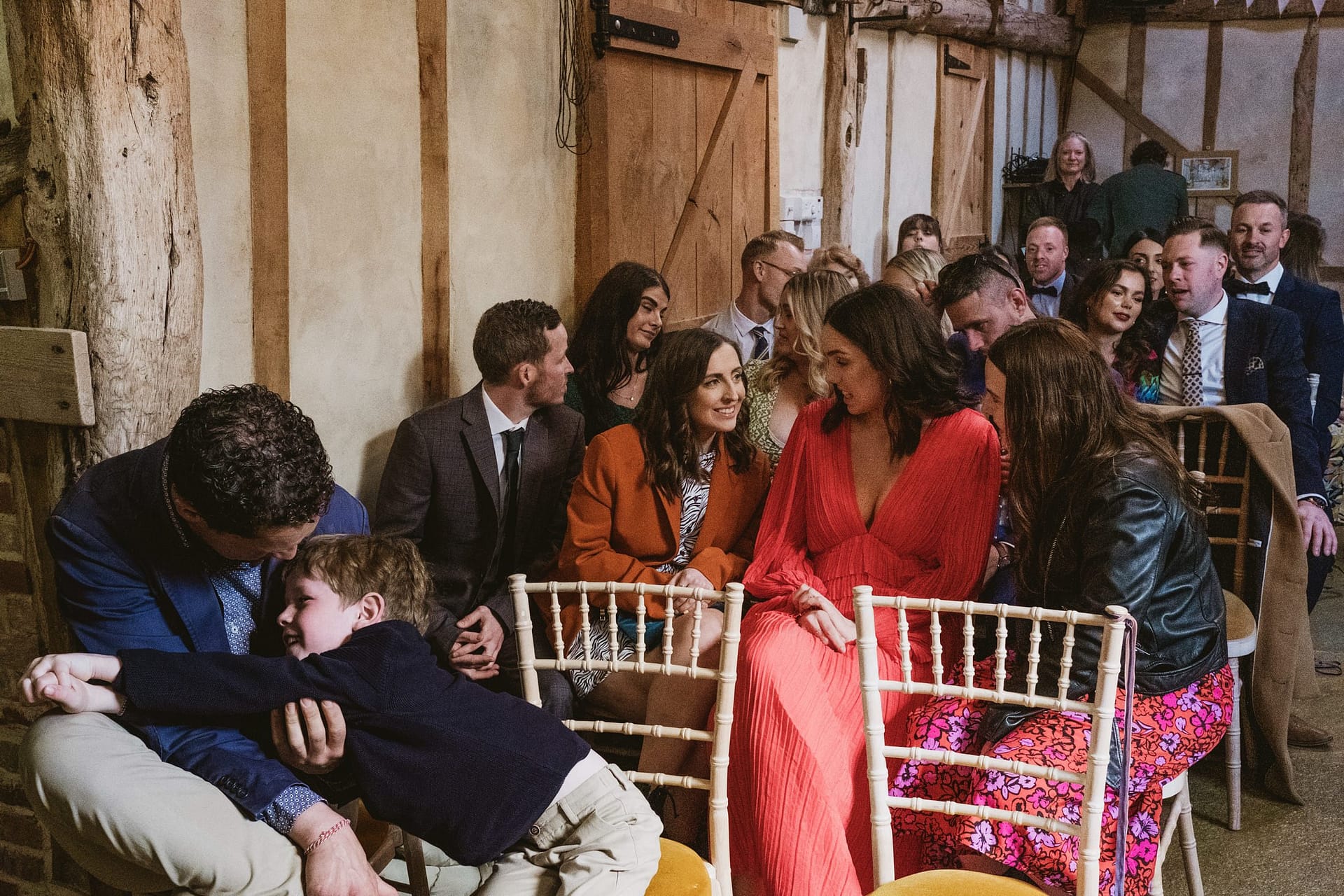 Alpheton Barns wedding ceremony, little boy hugs dad during the vows