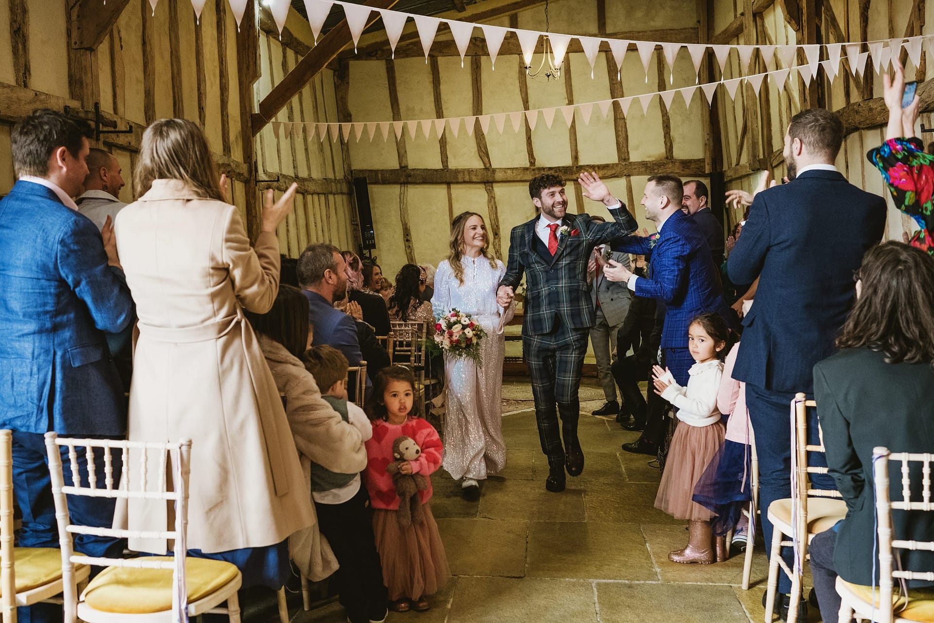 bride and groom first entrance as a married couple at Alpheton Barns