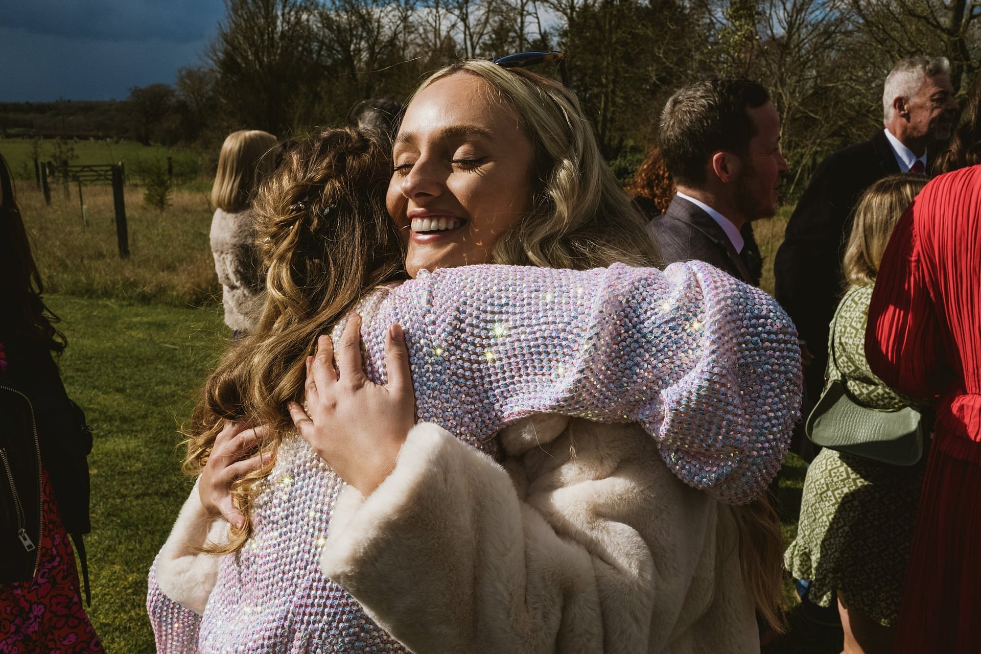 wedding guest hugging bride just after the ceremony at Alpheton Barns