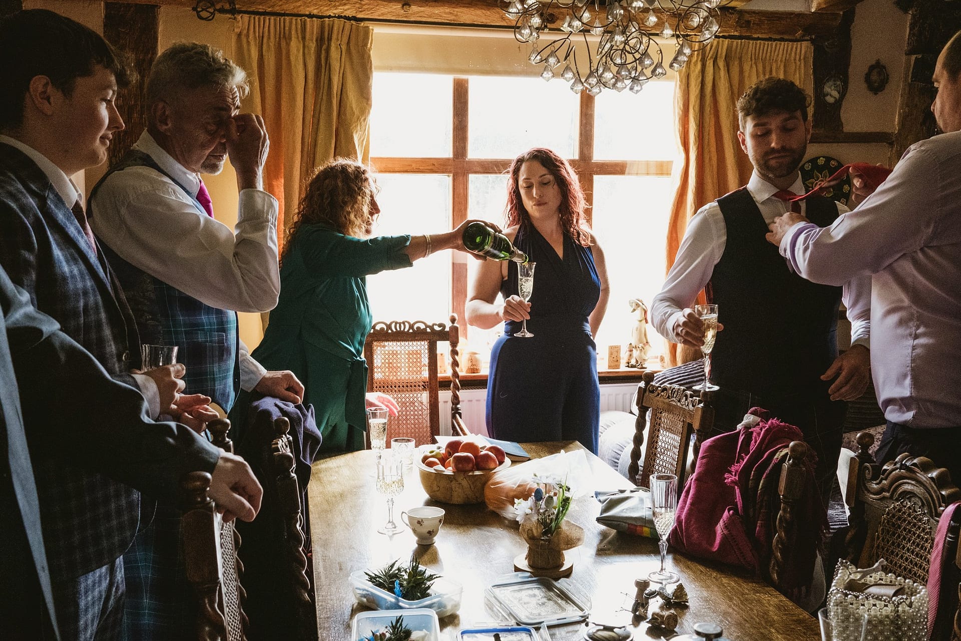 pouring champagne with the groomsmen in suffolk