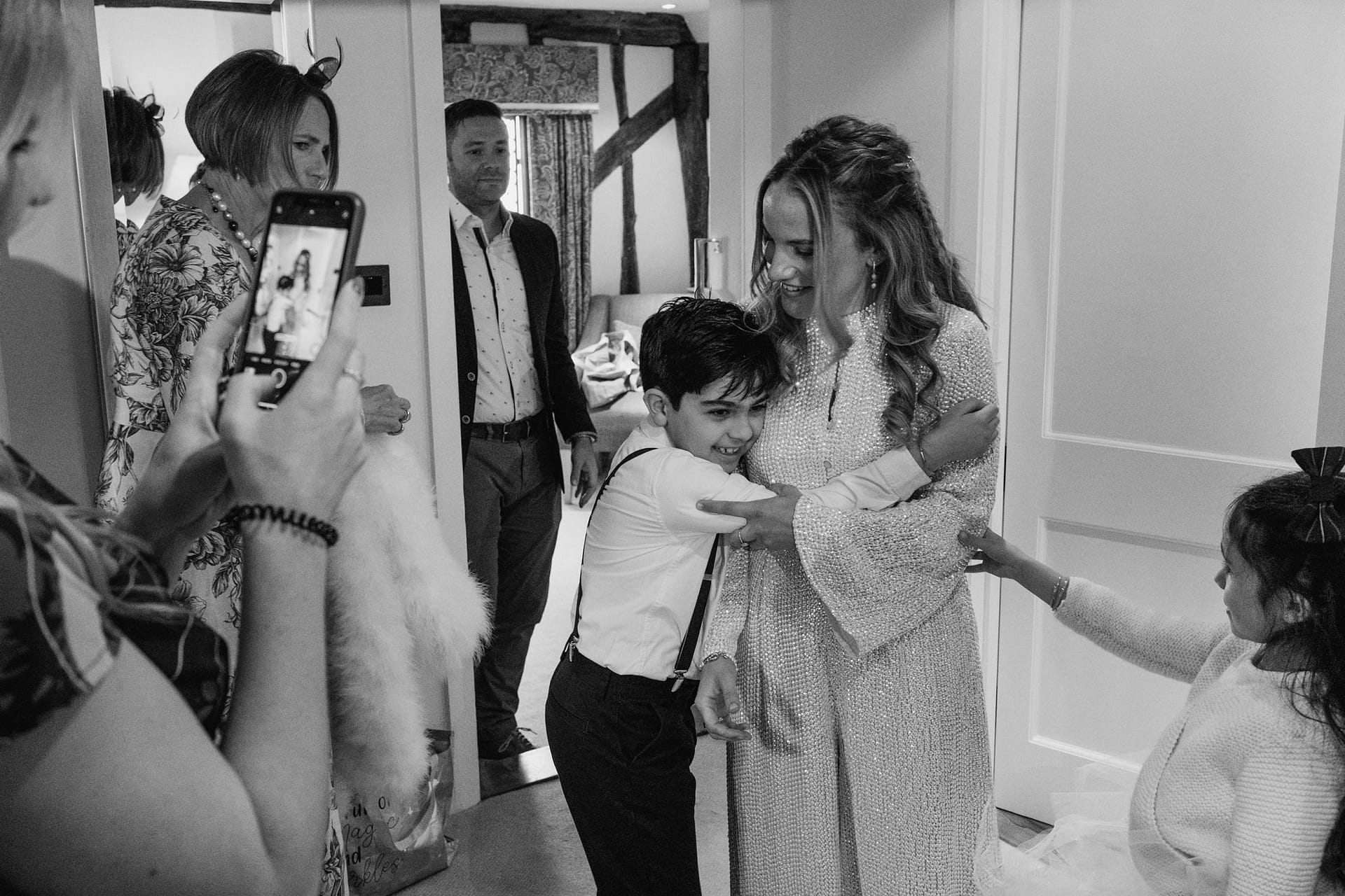 page boy hugging bride at Alpheton Barns before the ceremony