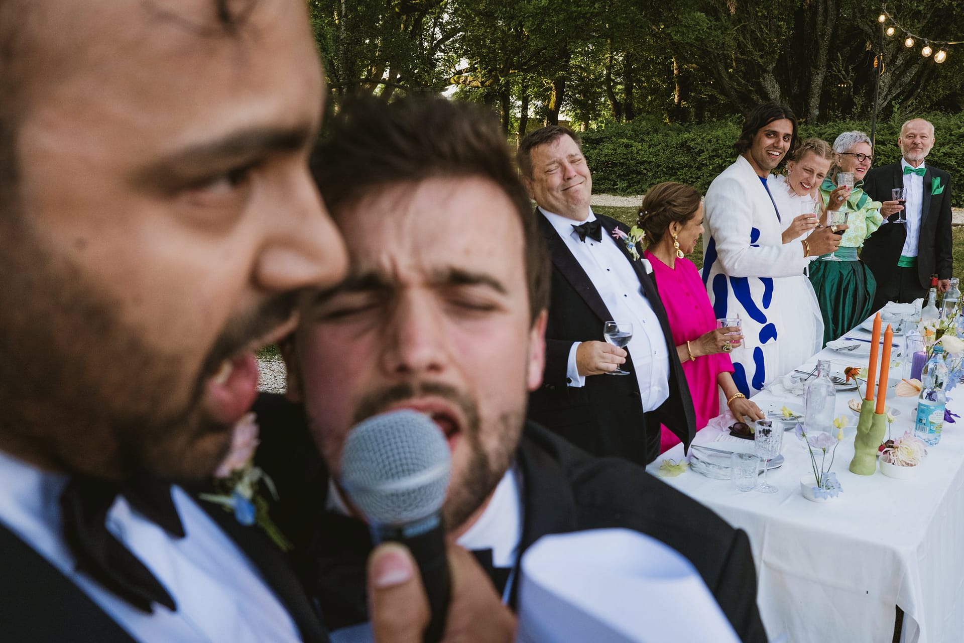 Chateau du Fey wedding photographers. An unusual point of view of the speeches with the wedding party laughing and looking on