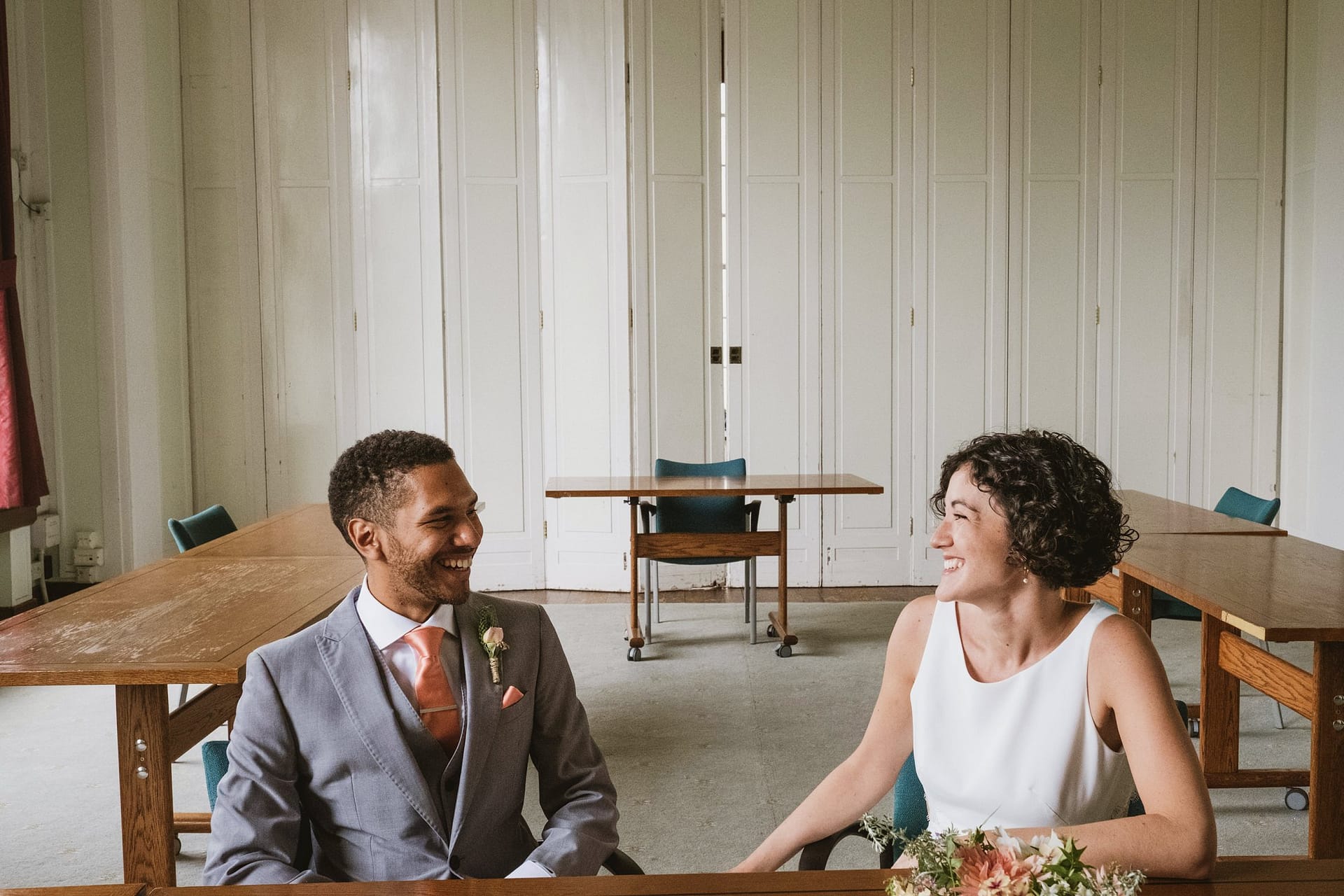 bride and groom waiting to see the register at islington town hall london