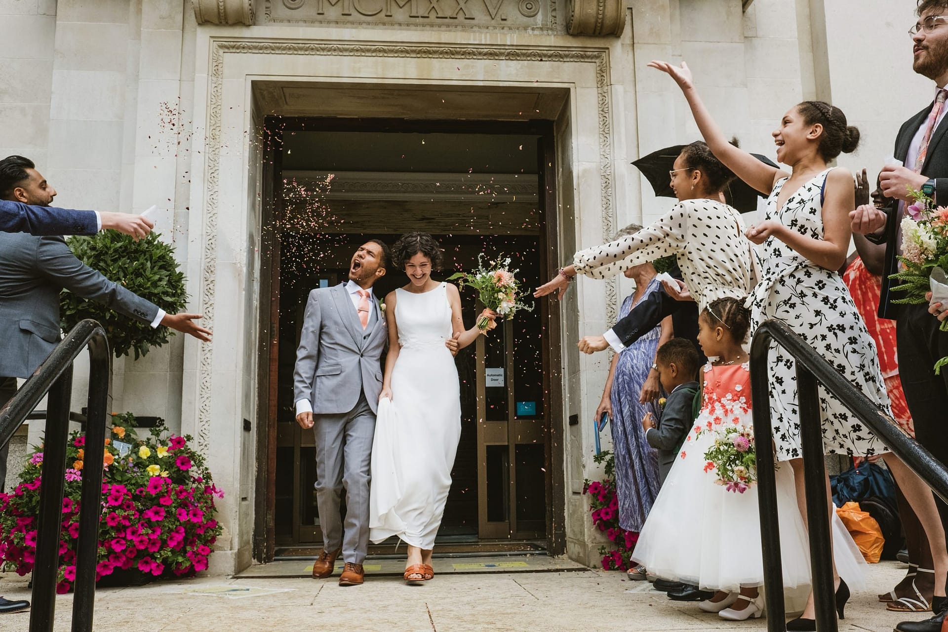 bride and groom walking out of Islington Town Hall