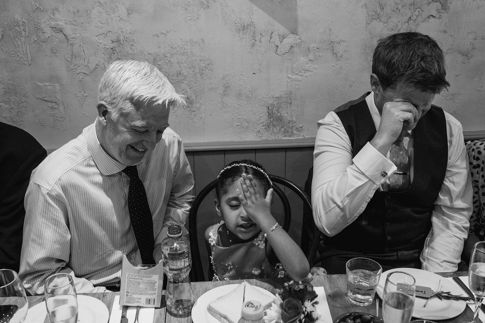 guests having a meal at La Farola restaurant flower girl has her hand on her head