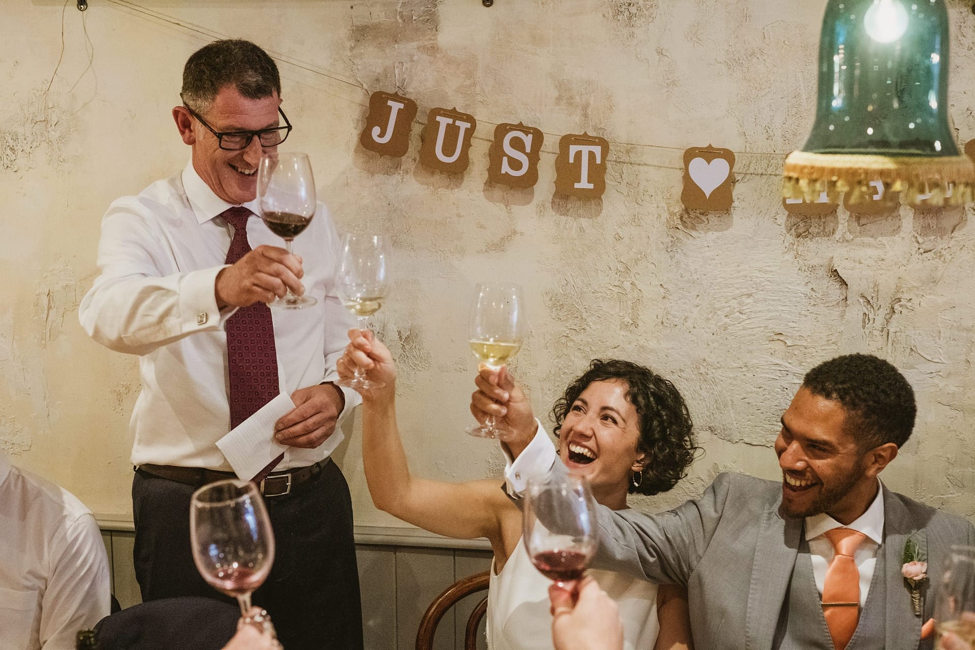 bride groom and father of the bride celebrating after the speech at La Farola restaurant