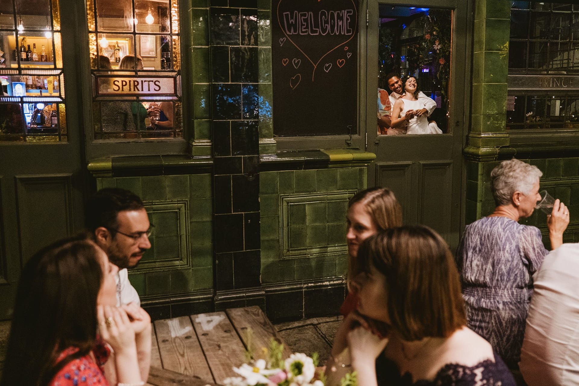 bride and groom dancing in window at Prince Albert Camden