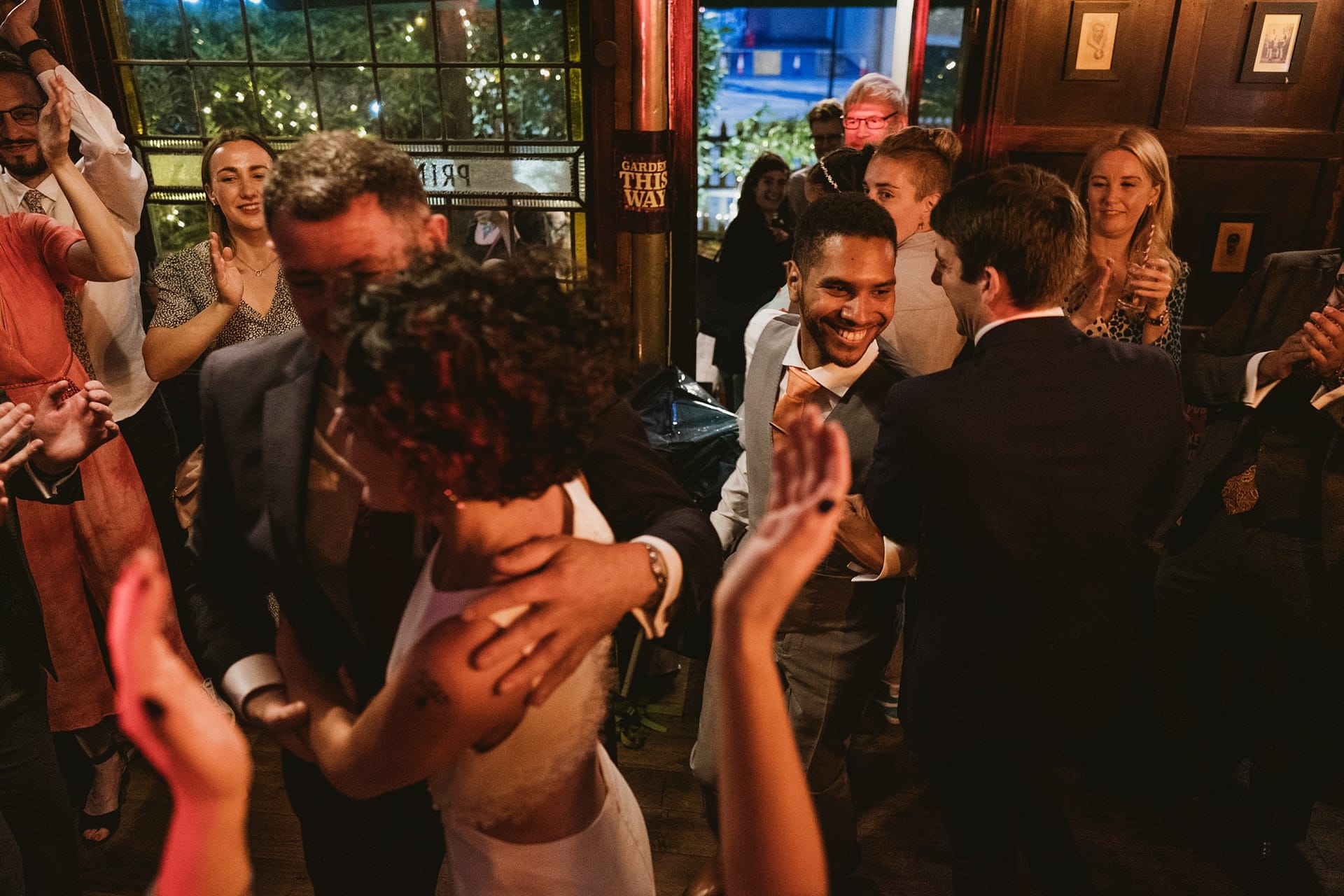 wedding guests hugging bride and groom at Prince Albert pub in Camden