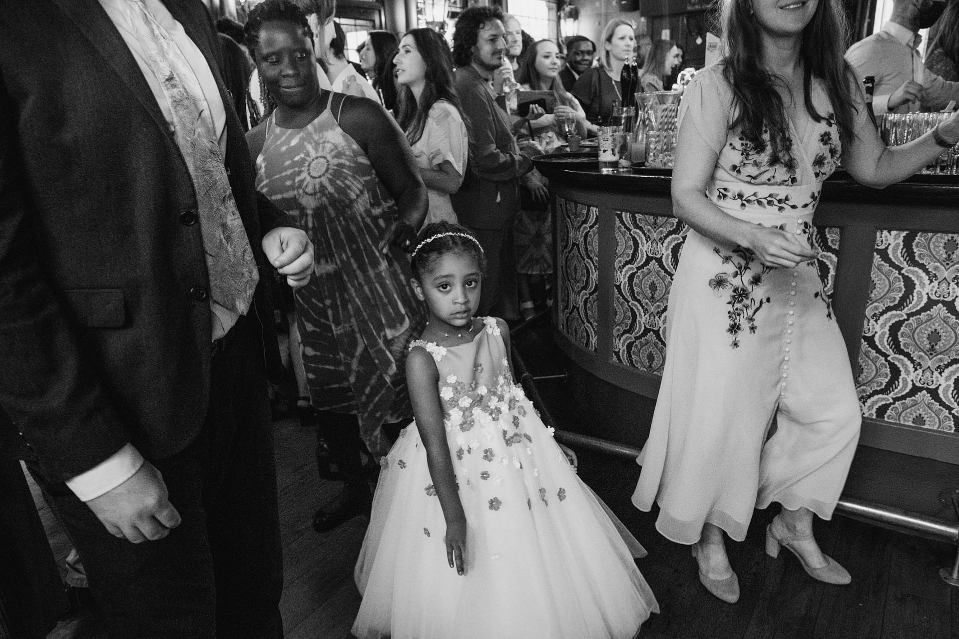flower girl listening to speeches at Prince Albert pub in Camden