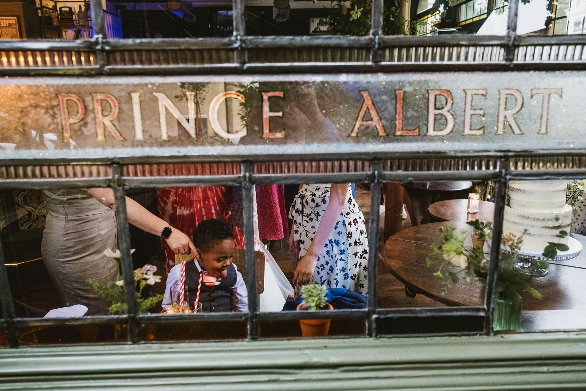 Prince Albert pub signage photographing page boy through the glass