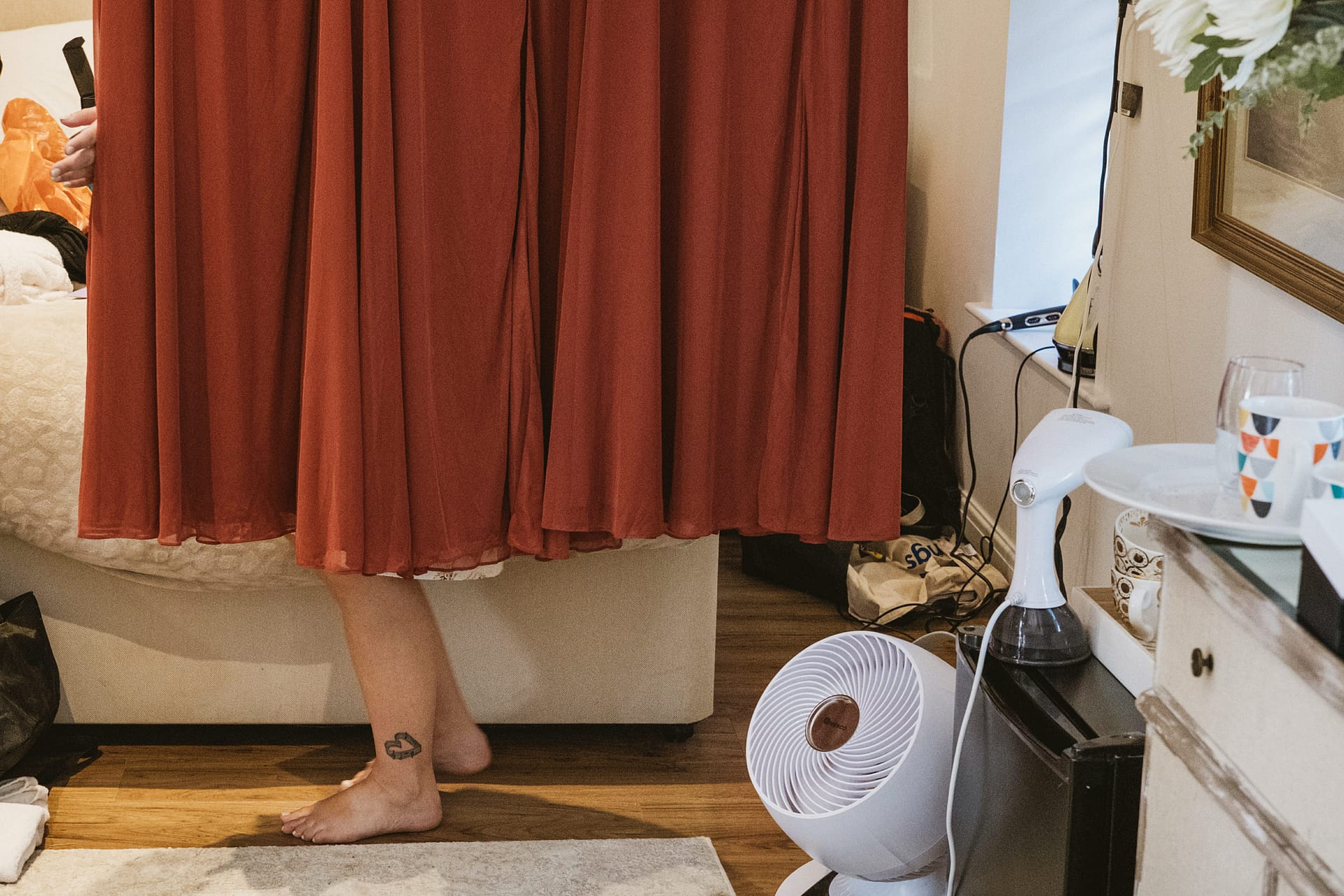 Red dress, tattooed leg, room interior view