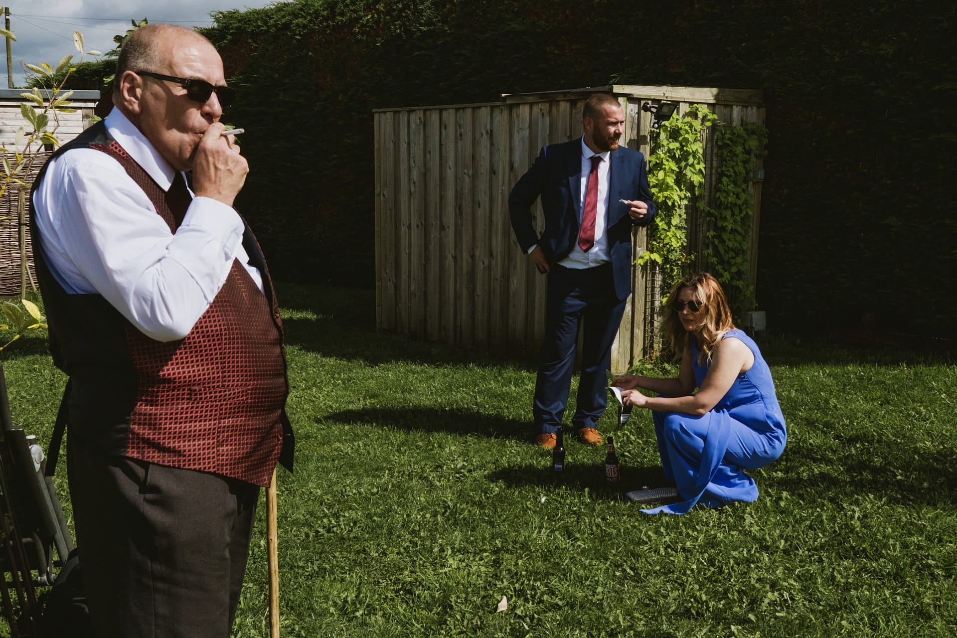 People socialising outdoors in formal attire.