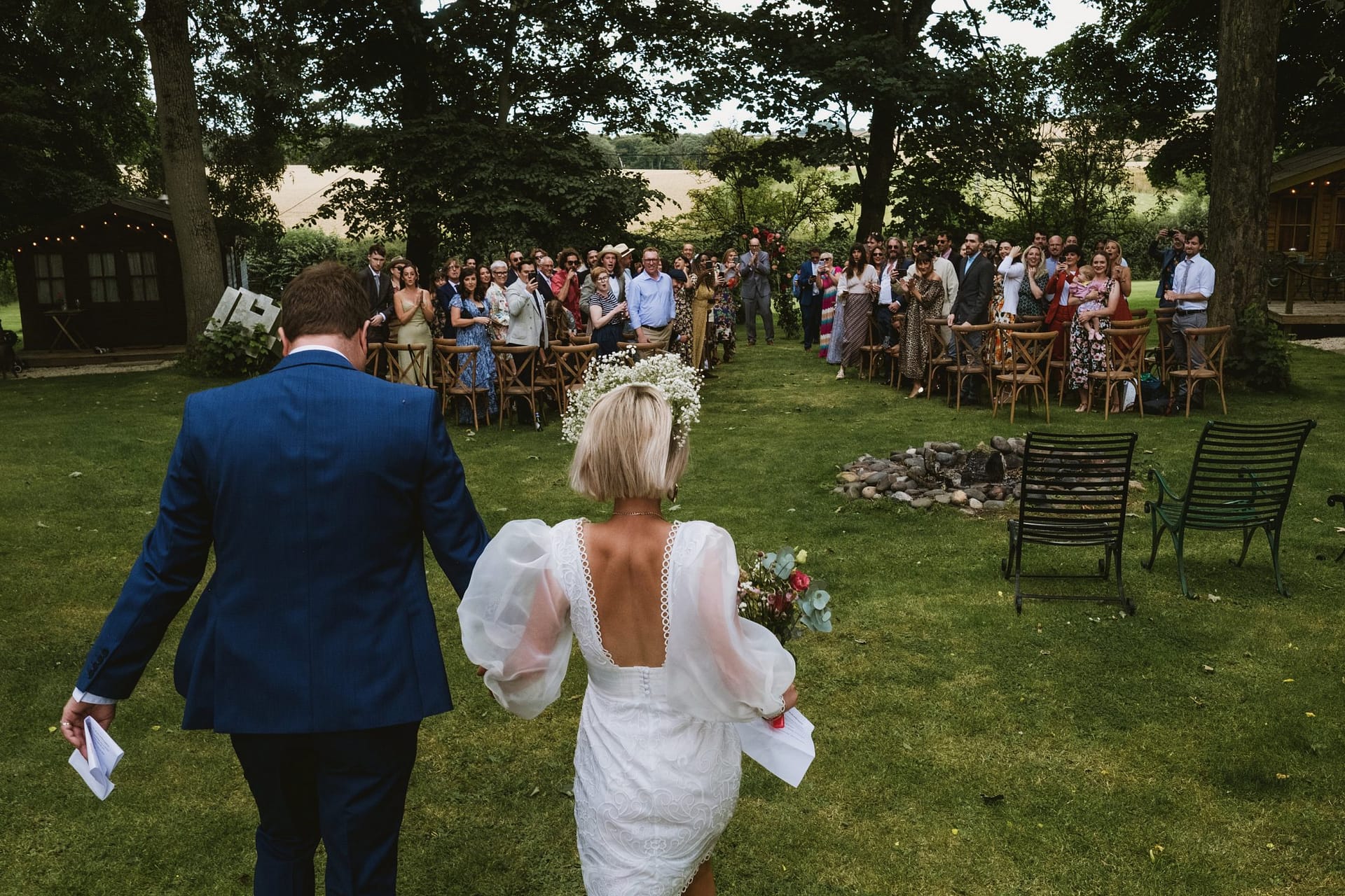 Bride and groom's wedding entrance in the outdoor ceremony