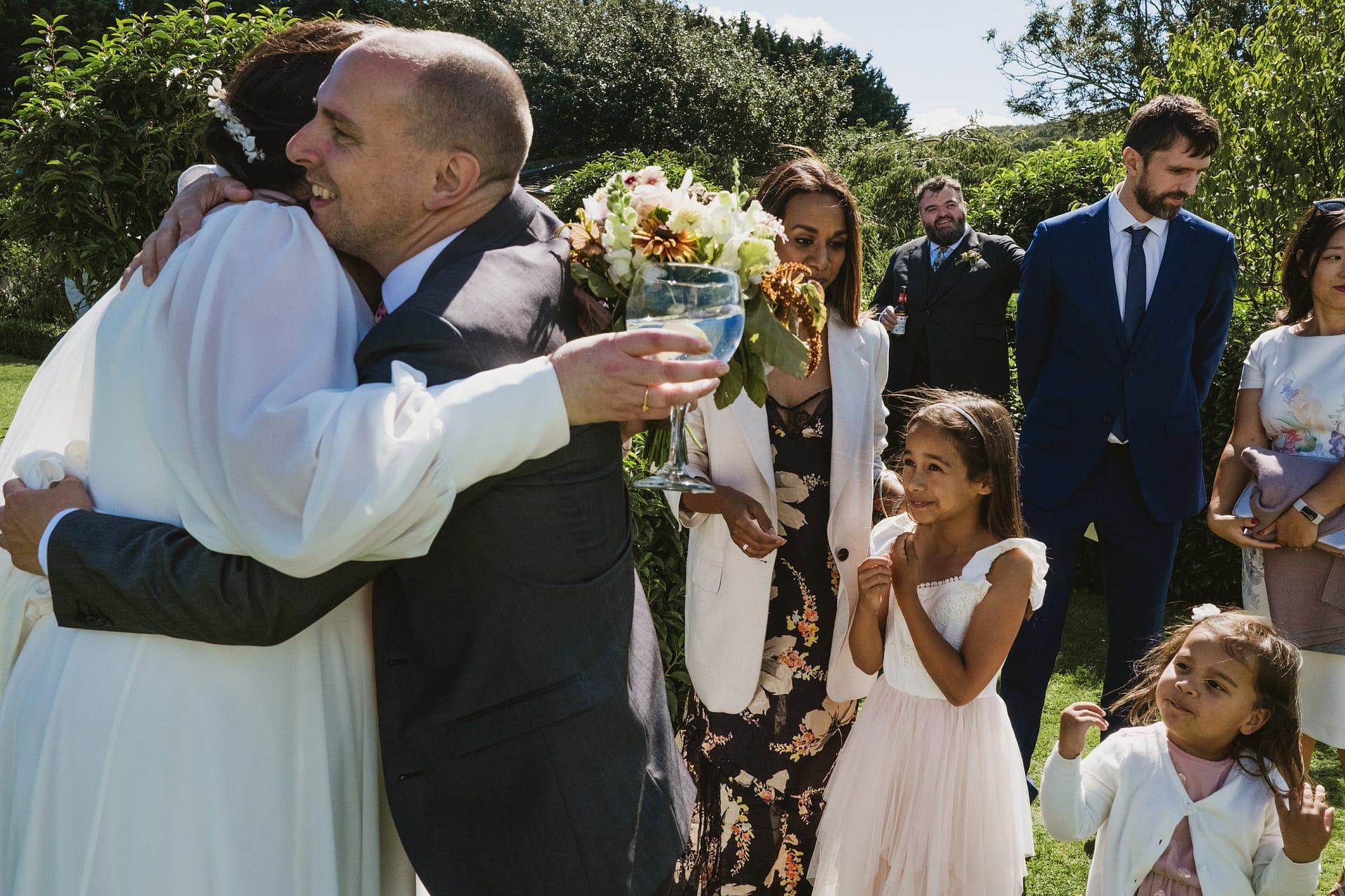 Wedding guests greeting and smiling outdoors