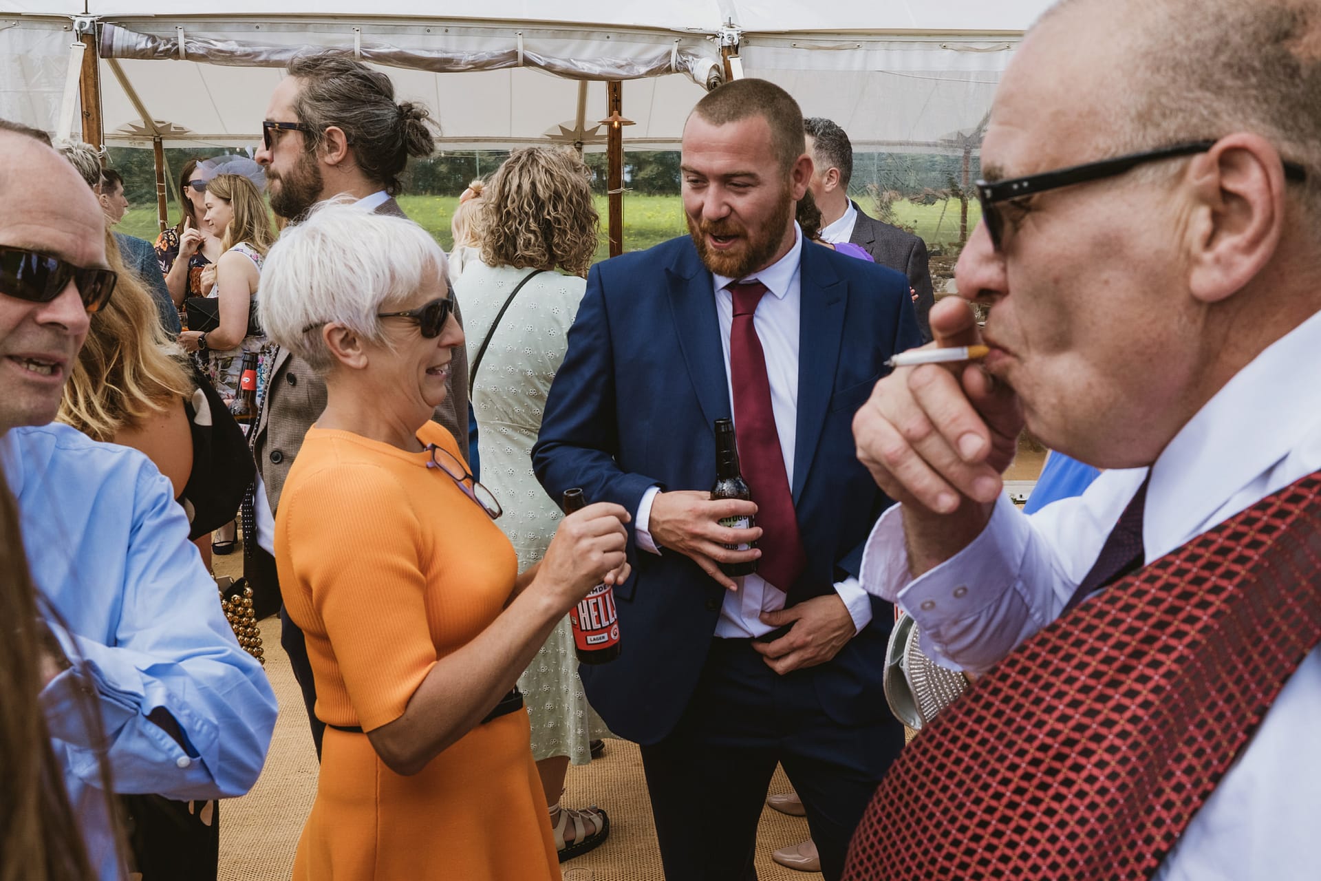 Group of people socialising at an outdoor event.