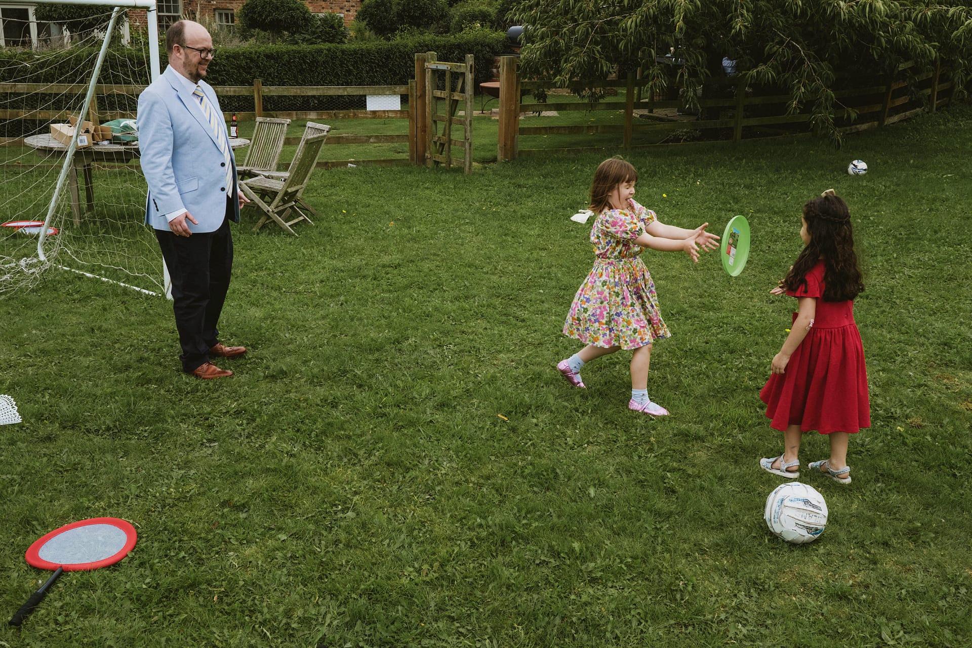 Children playing frisbee in the garden.