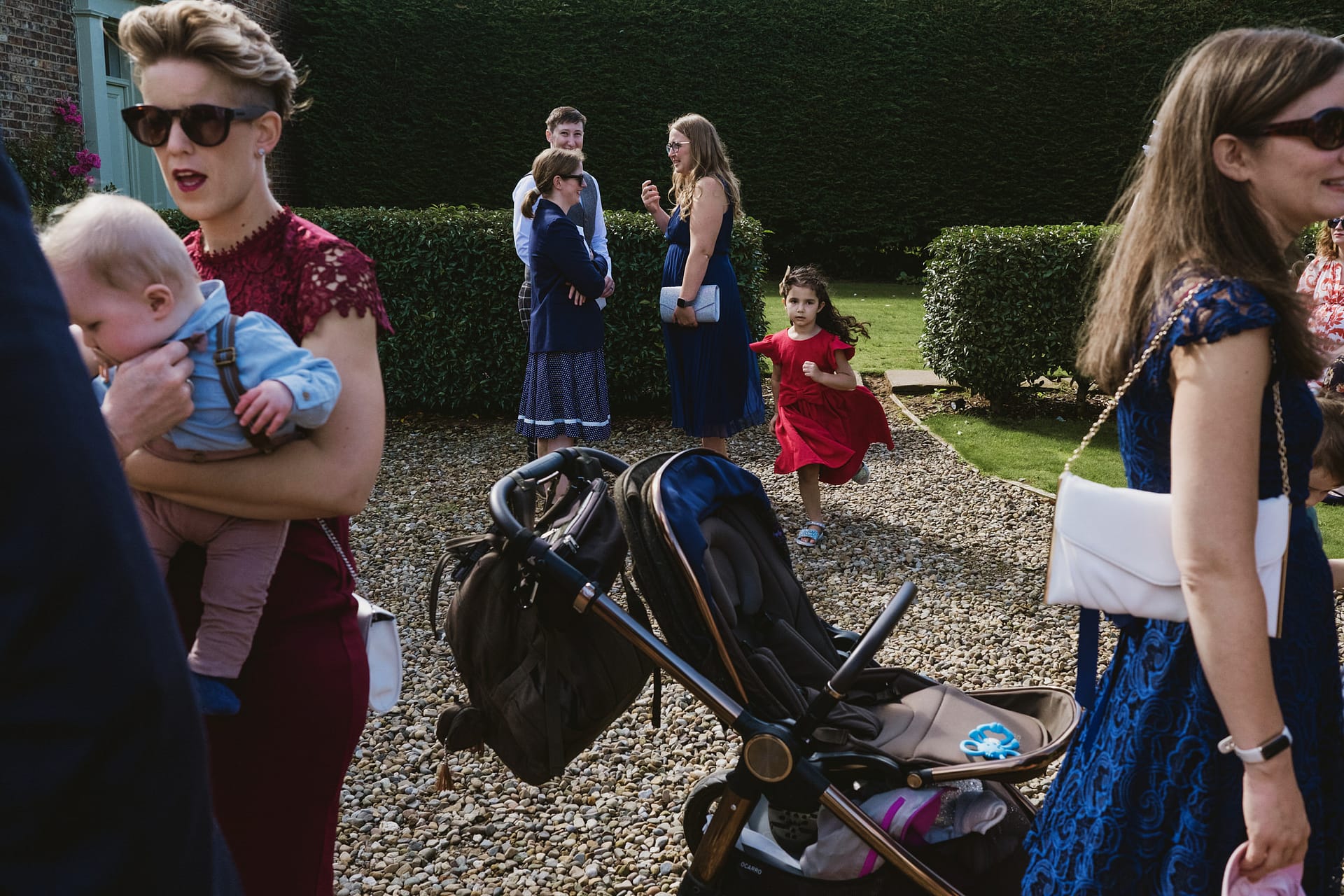 Group at outdoor event with child running.