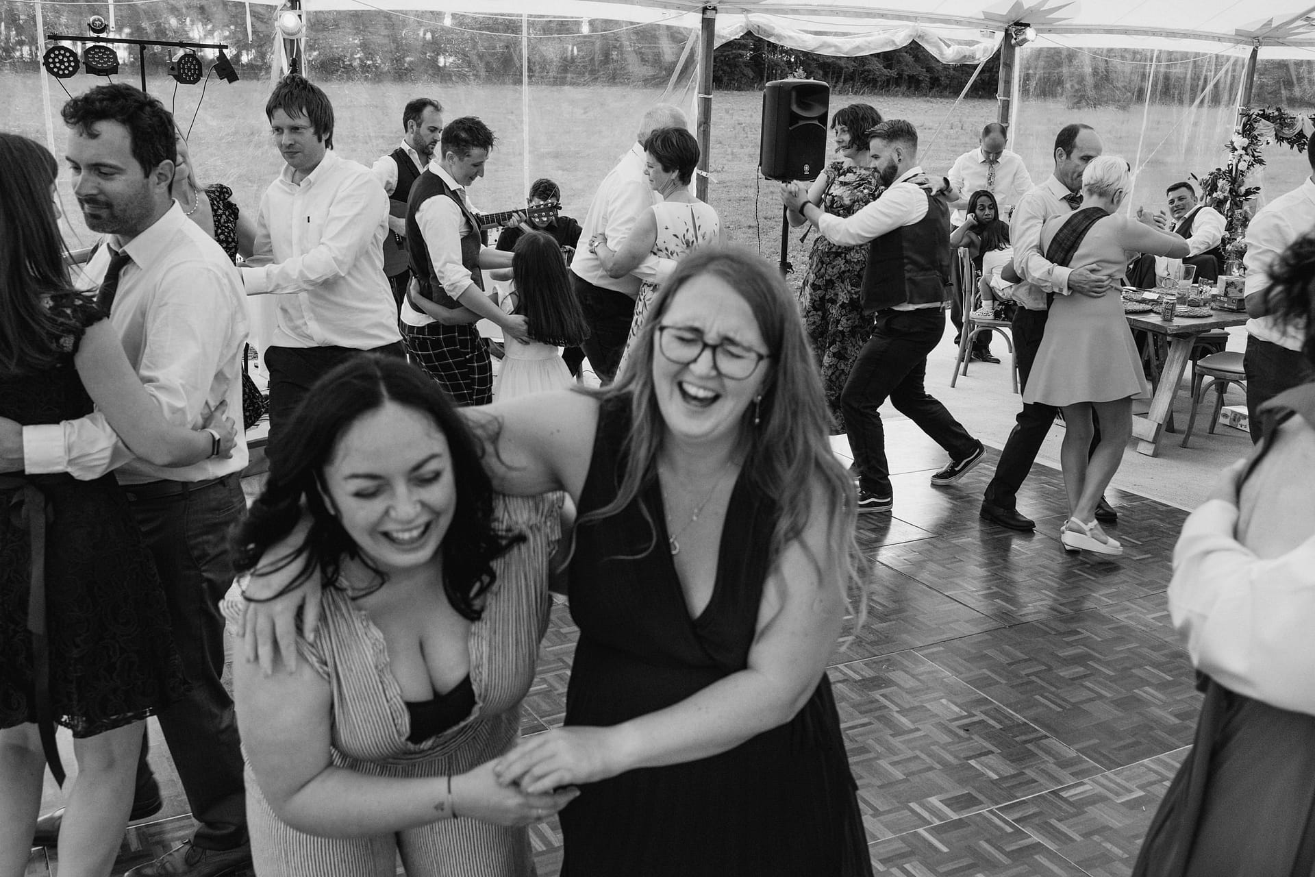 People dancing joyfully at an outdoor event.
