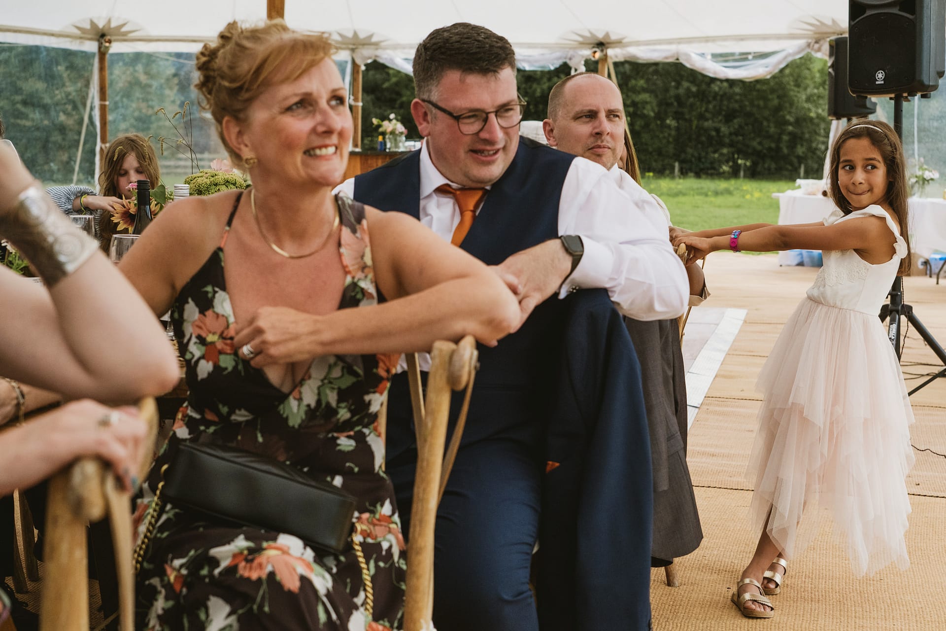Guests enjoy wedding reception inside marquee.
