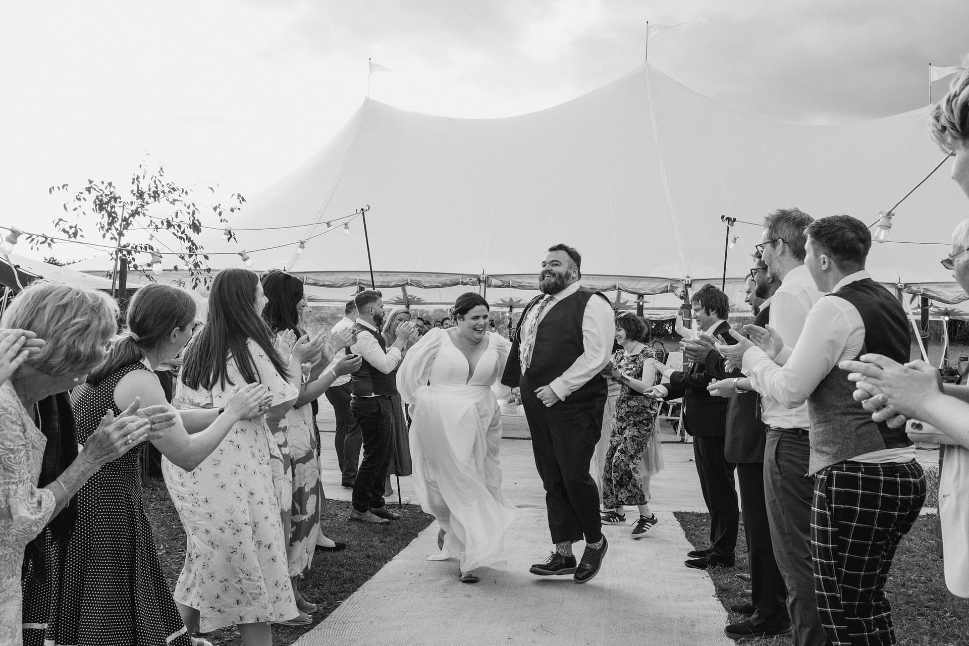 Bride and groom celebrating with guests at wedding