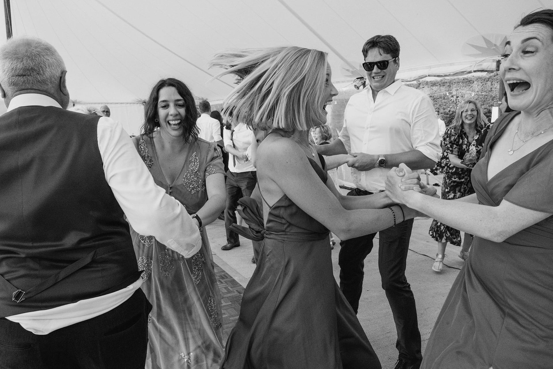 Group of people dancing joyfully at a party.