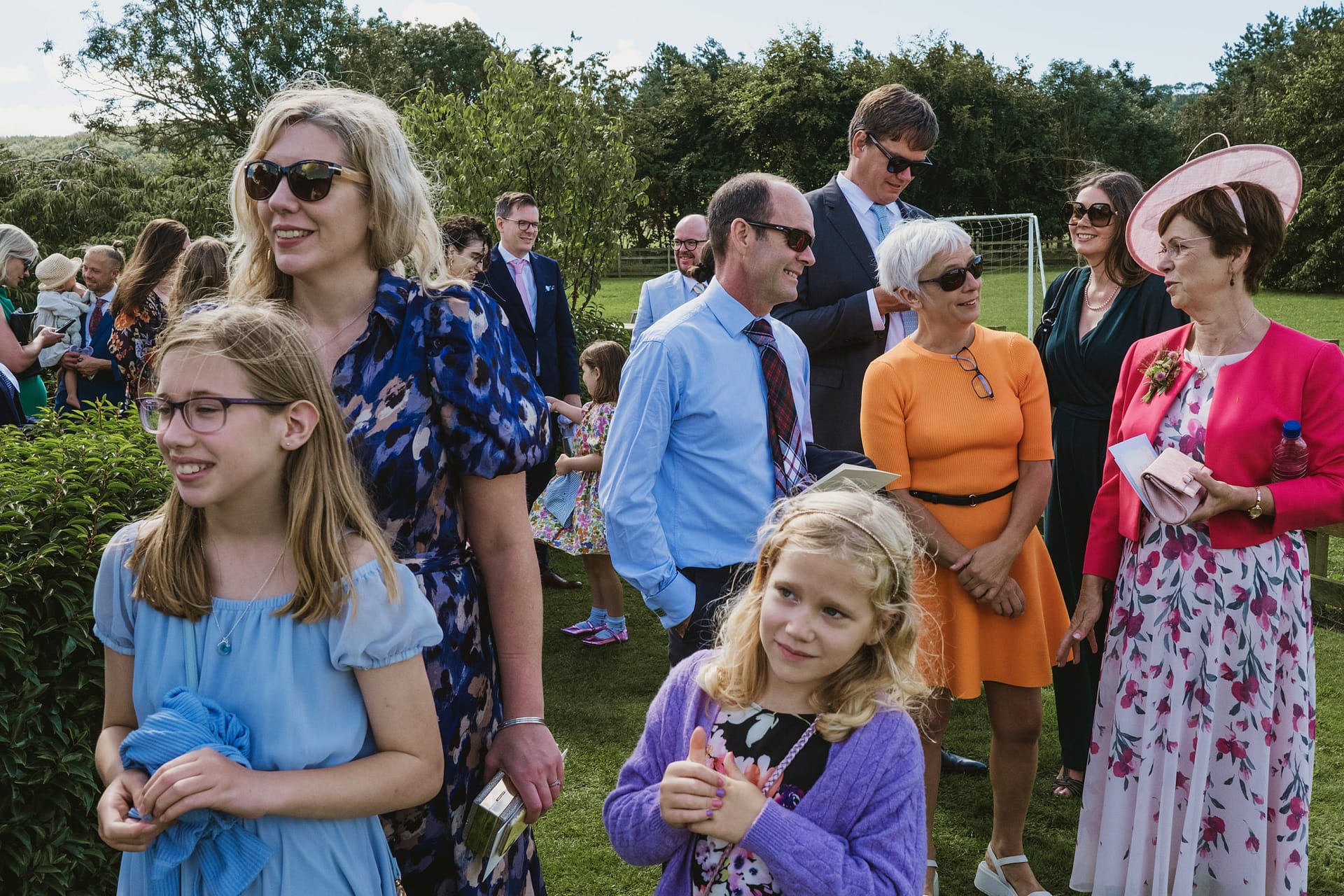 Group of people at outdoor gathering, smiling.