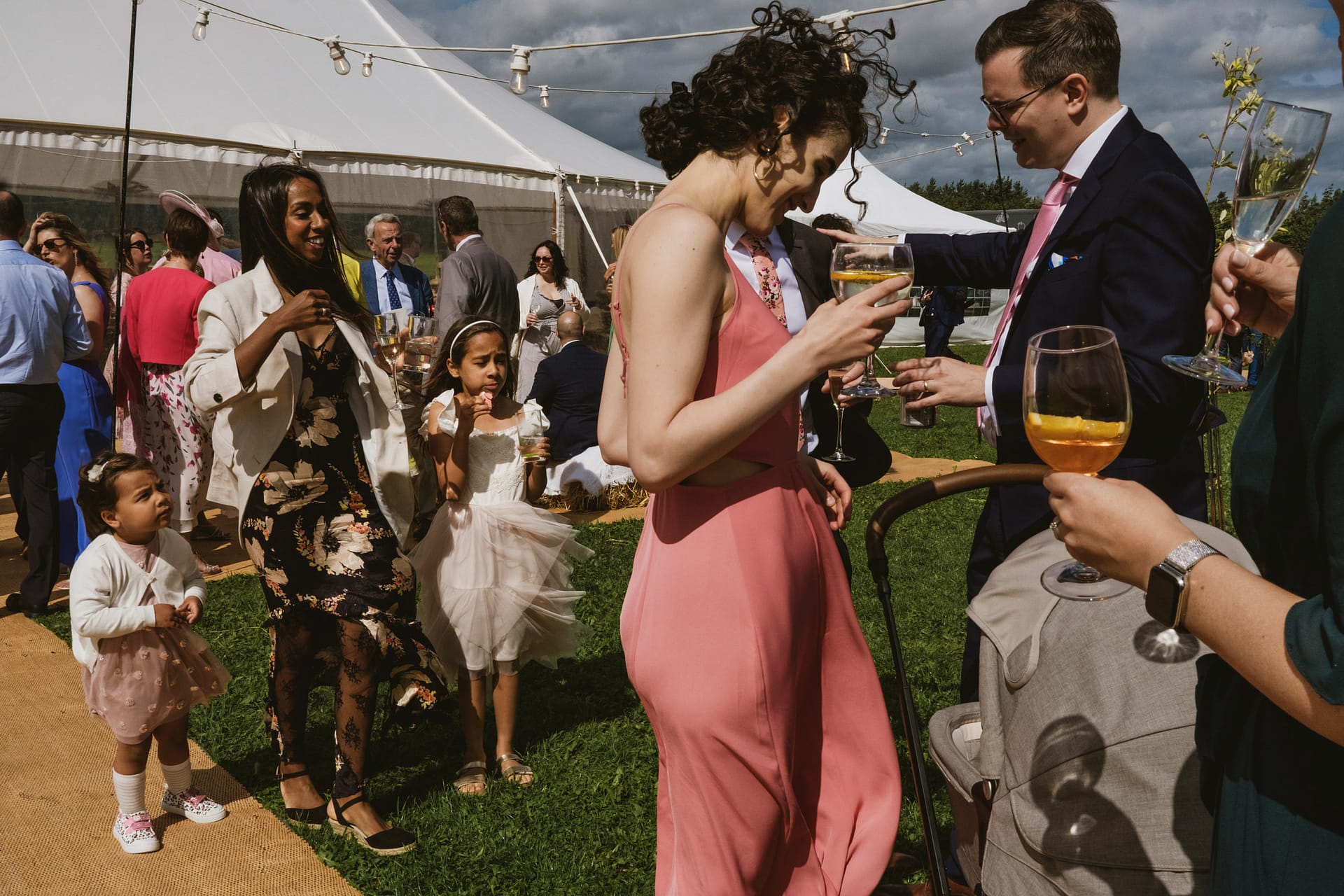 People celebrating outdoors at a wedding reception.