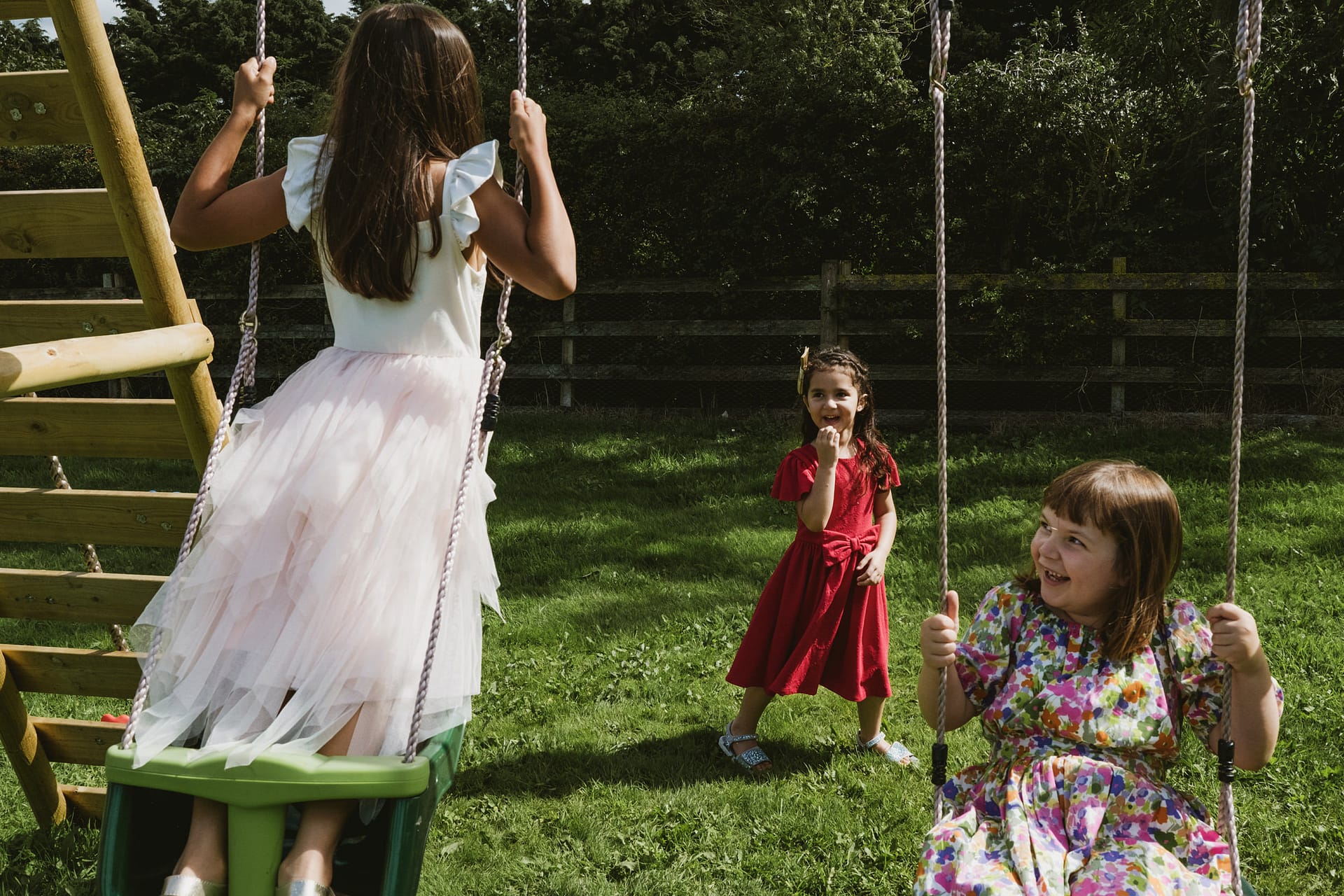 Children playing on swings in a garden