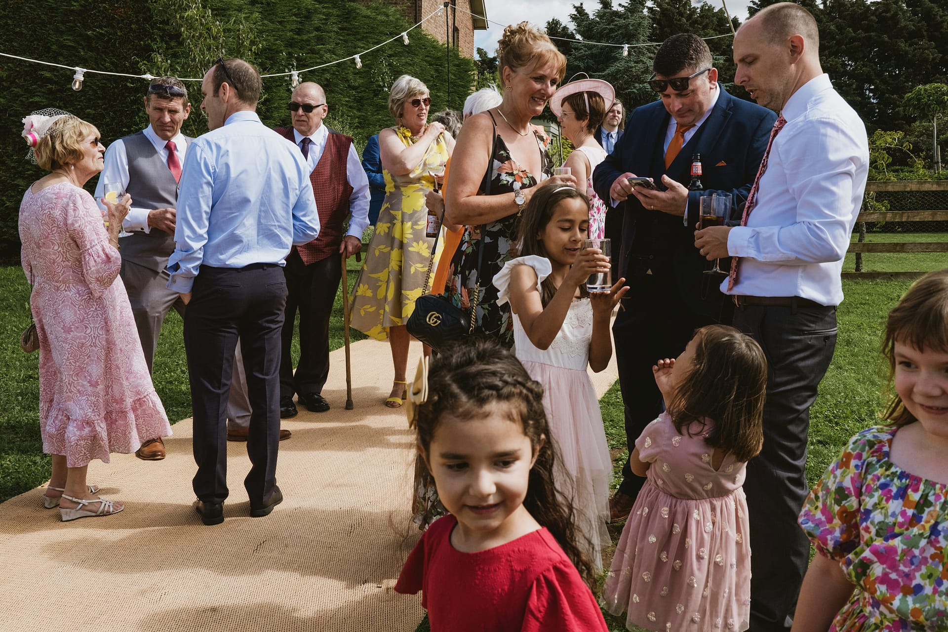 Group attending outdoor wedding celebration, smiling.