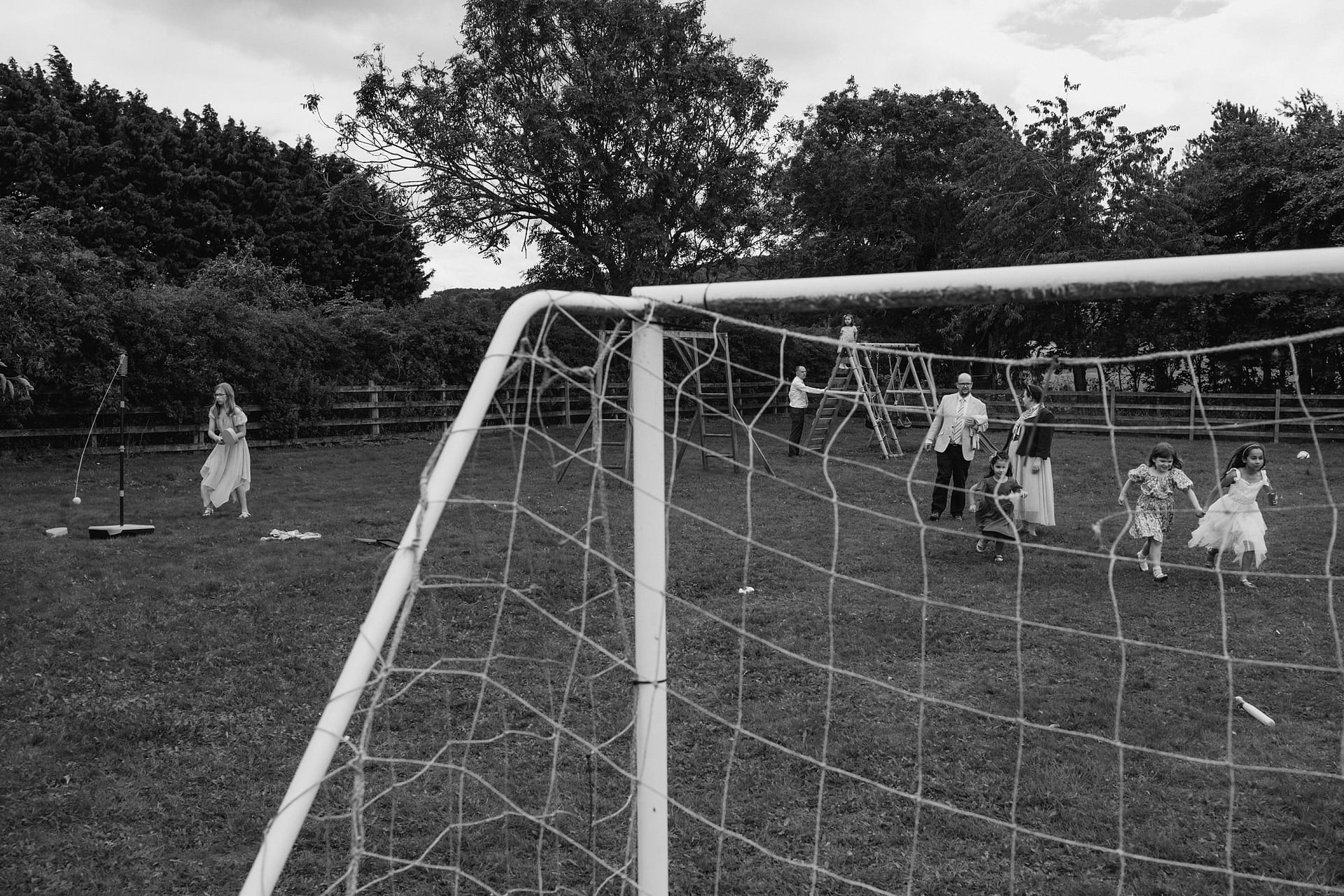Children playing in a park with climbing frame.
