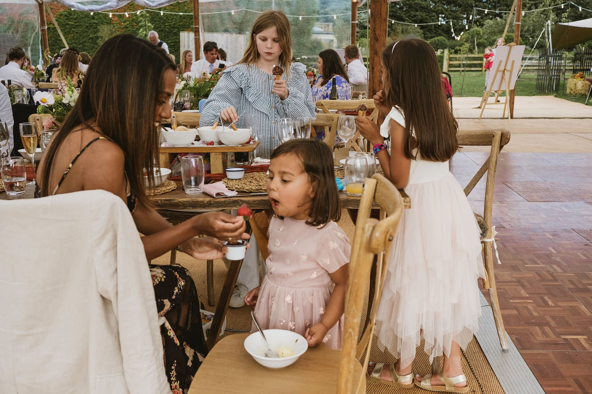 Children enjoying dessert at a garden party.
