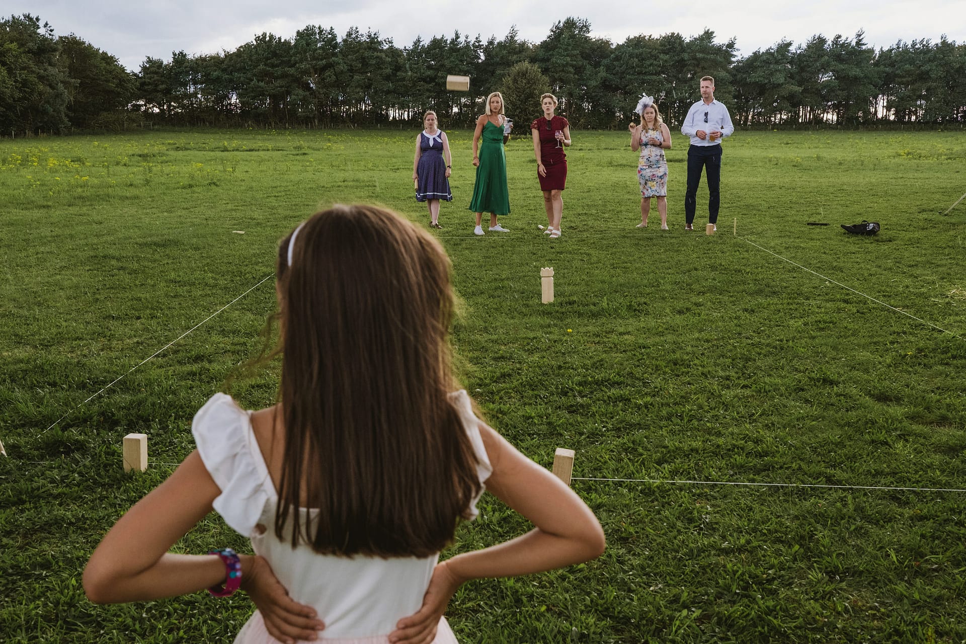 People playing a game in a grassy field.