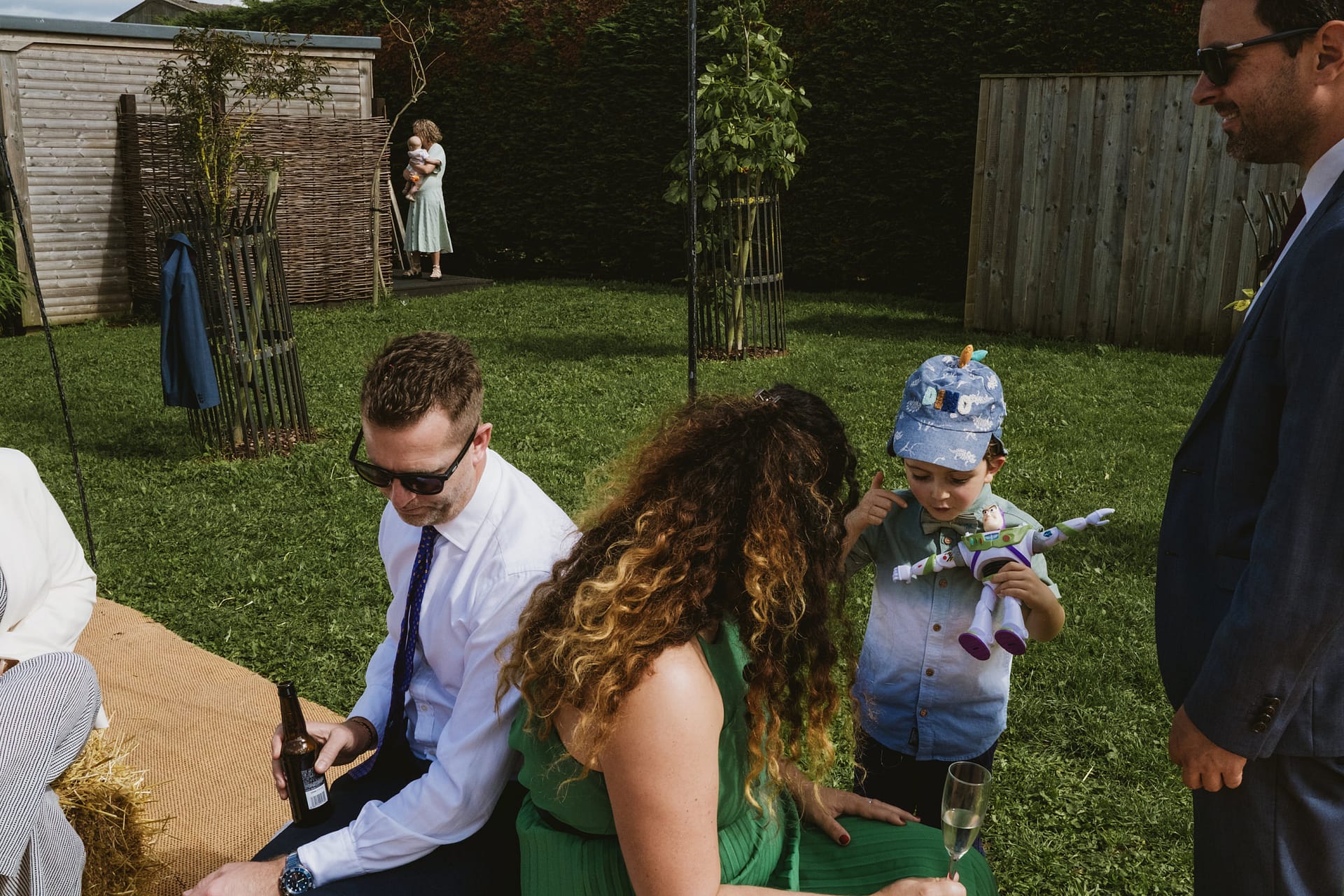 Garden gathering with adults and children playing.