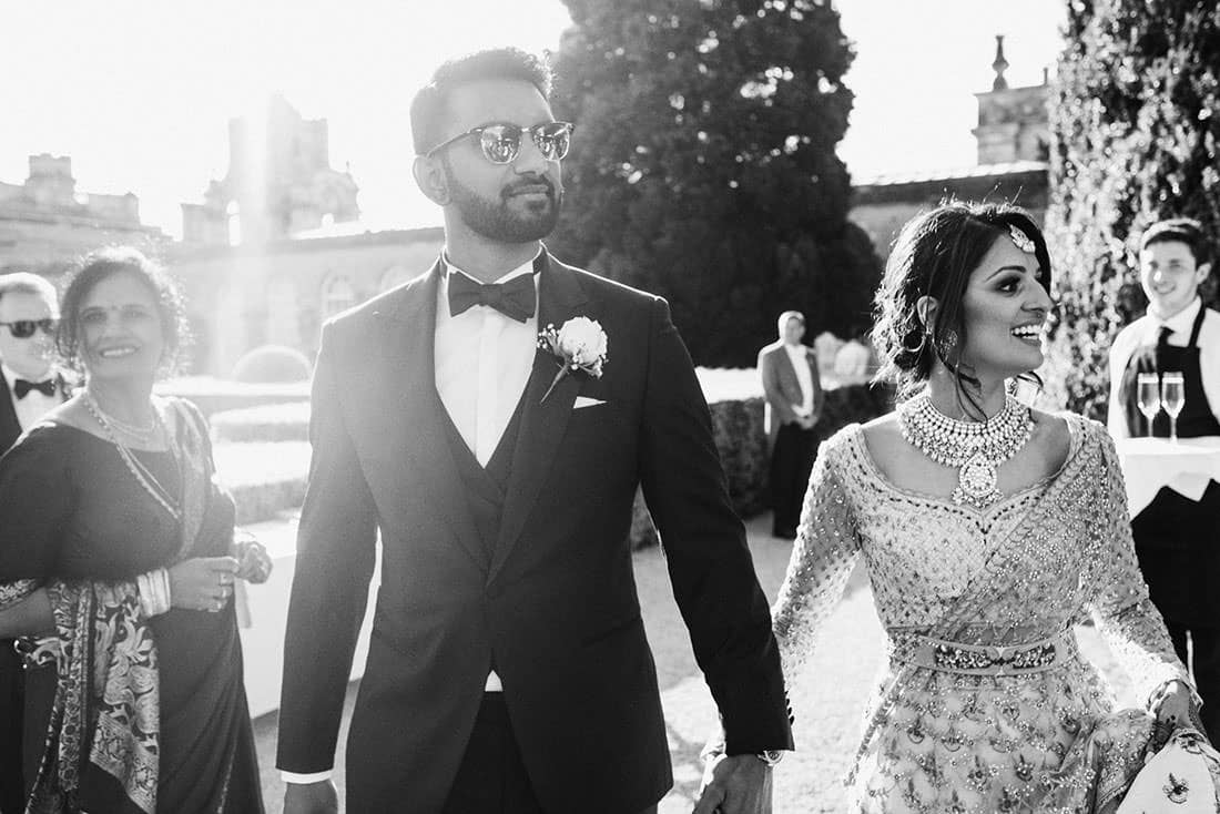 Blenheim Palace Wedding Photography. Bride and Groom arrive to reception arm in arm.