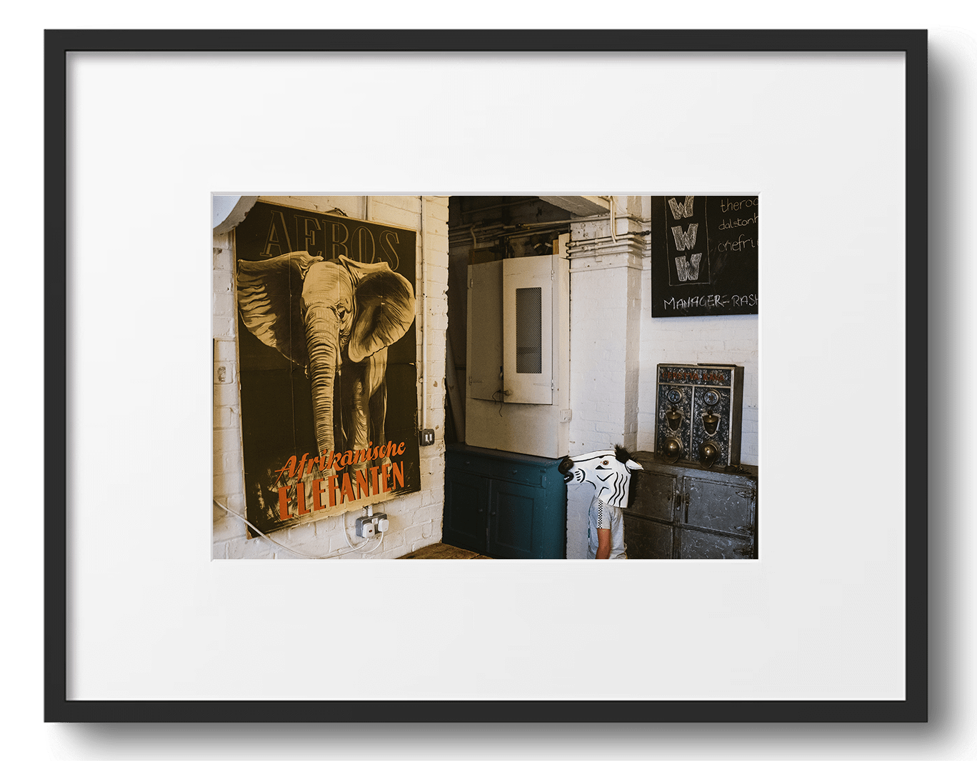 Elephant poster meets boy in zebra mask at an East London Wedding. Picture of the week by York Place Studios