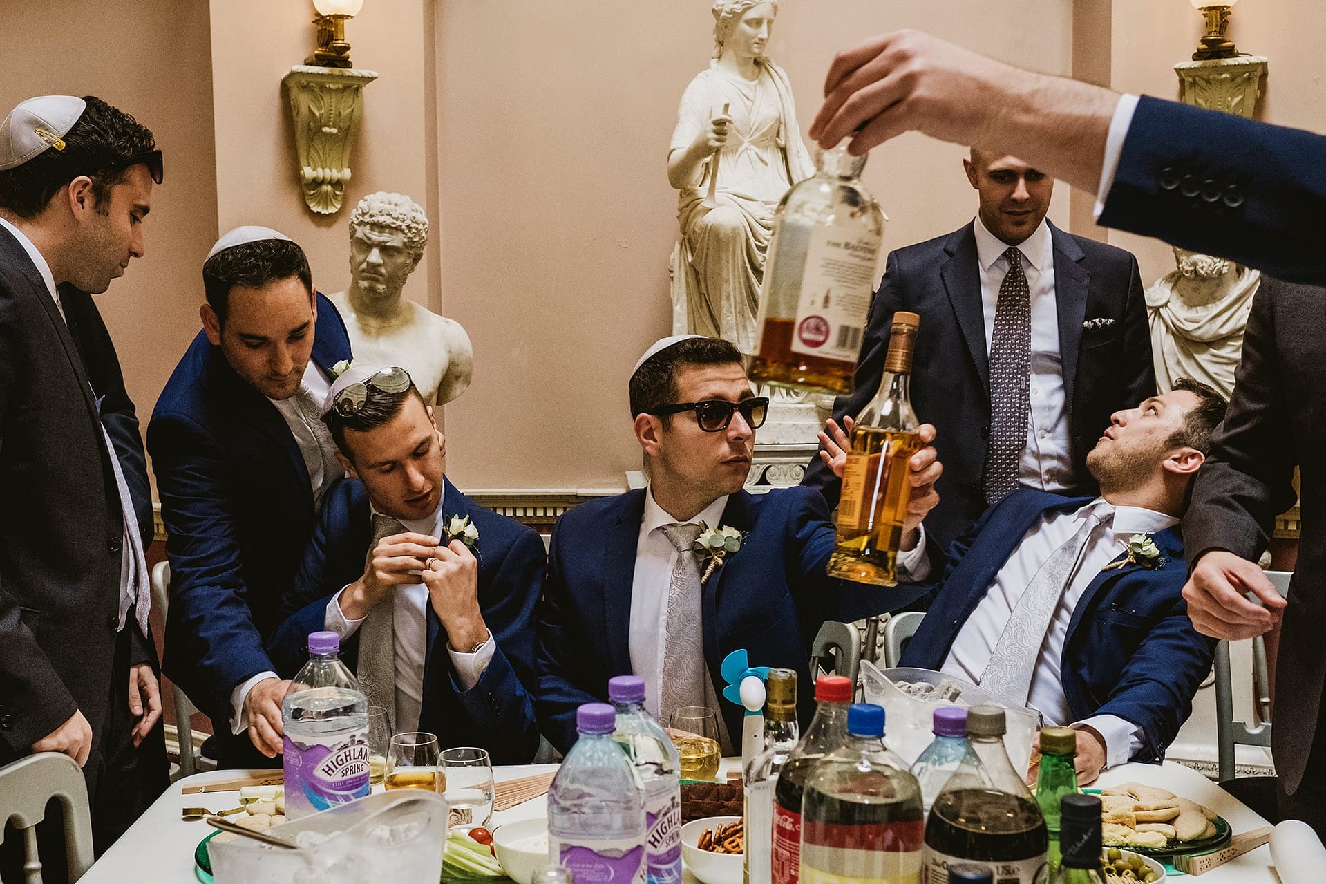 Newby Hall Jewish groom preparations. Drinking whiskey with the groomsmen and putting on button holes