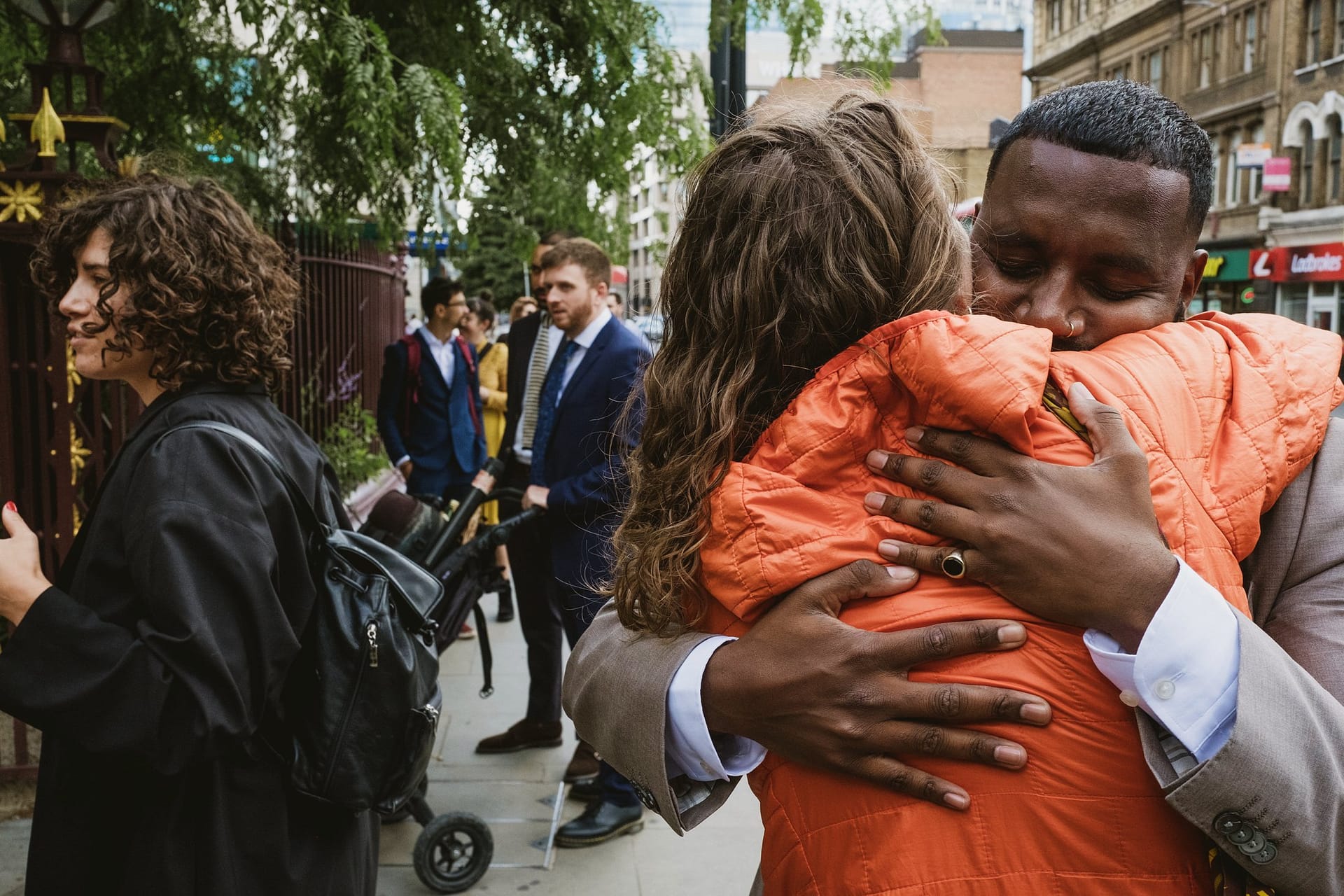 A man and woman hugging on St Botolph without Aldgate street.