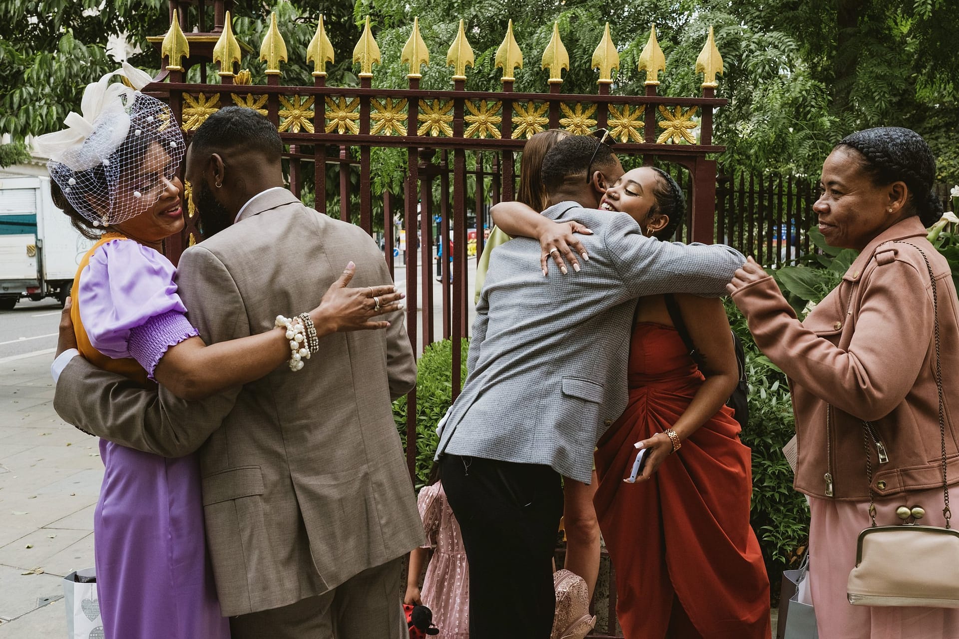 A group of people hugging in front of the St Botolph without Aldgate gate.