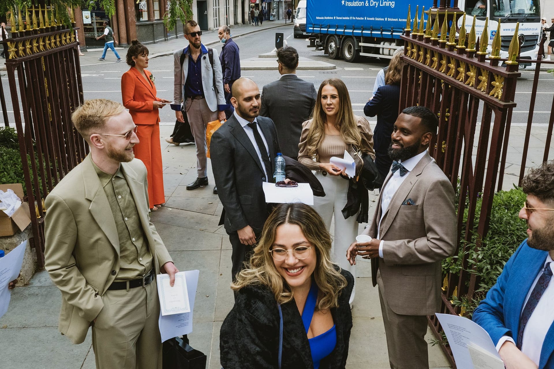 A group of people standing in front of the St Botolph without Aldgate gate.