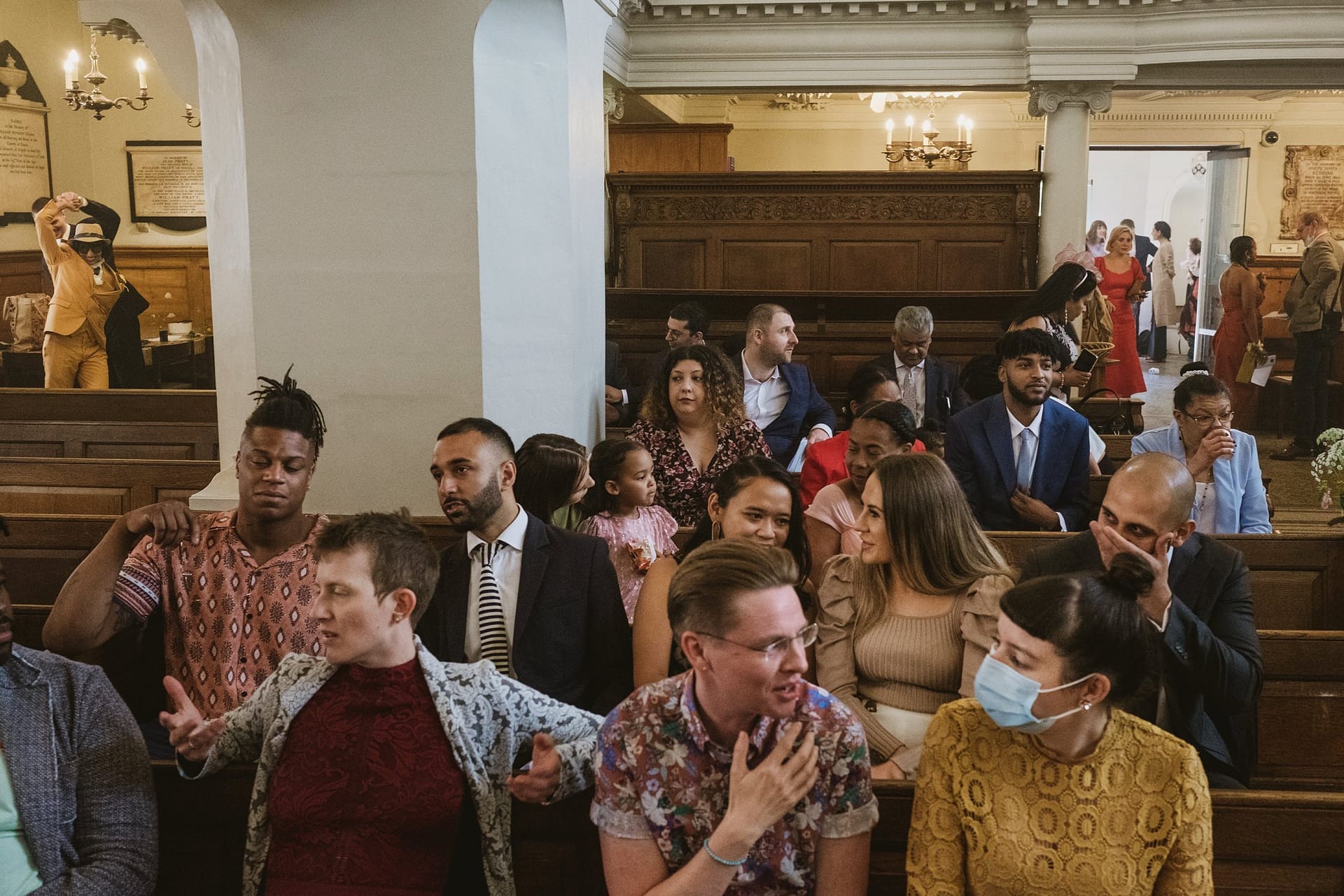 A group of people sitting in St Botolph without Aldgate church.