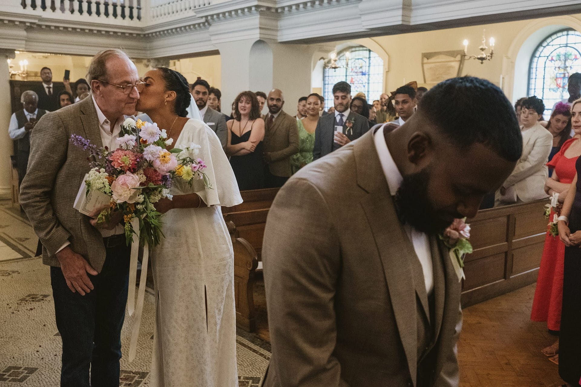 A bride and bride's father sharing a kiss during the St Botolph ceremony