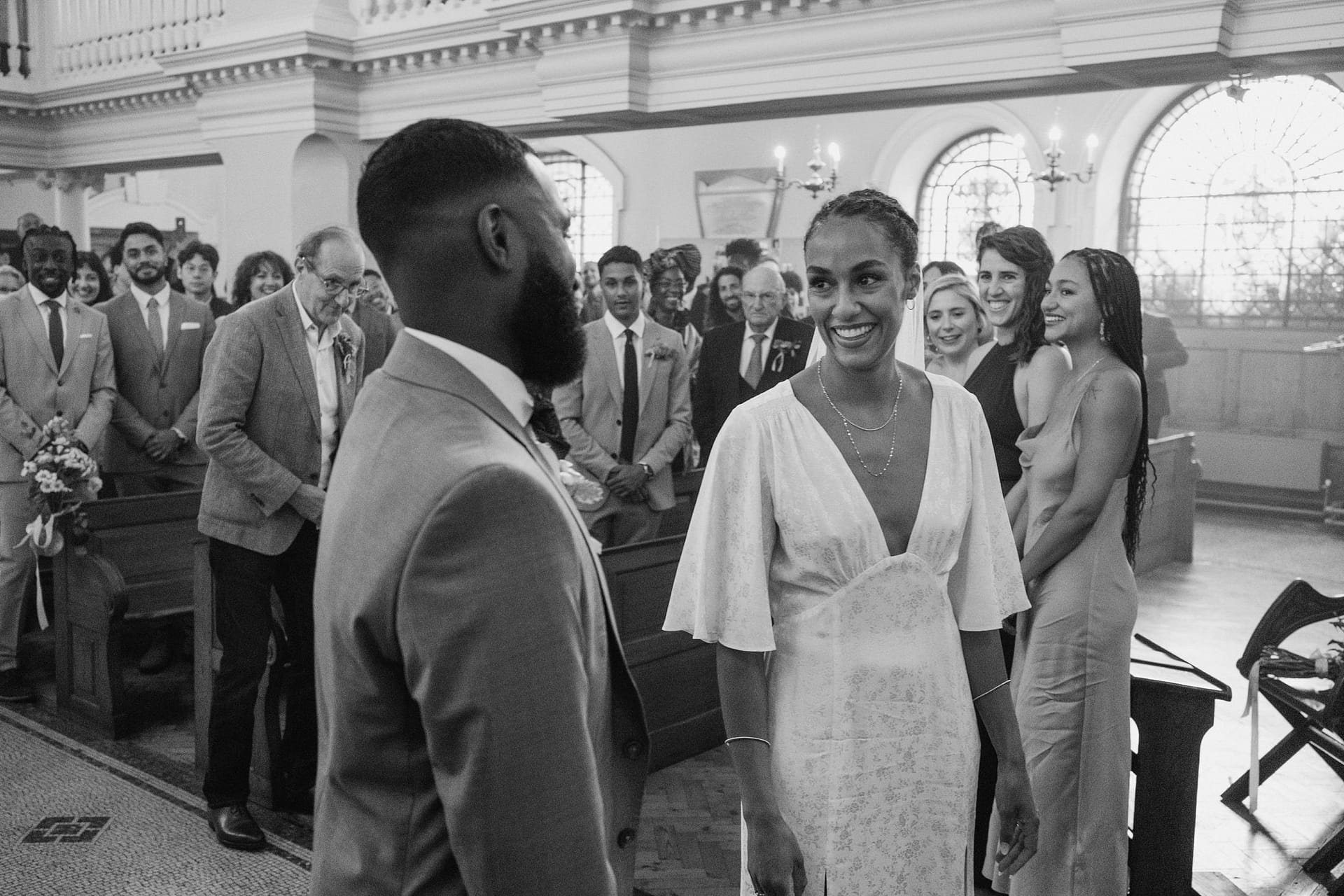 Greenwich Yacht Club Wedding Photography captures a tender moment as a bride and groom exchange glances in a church.