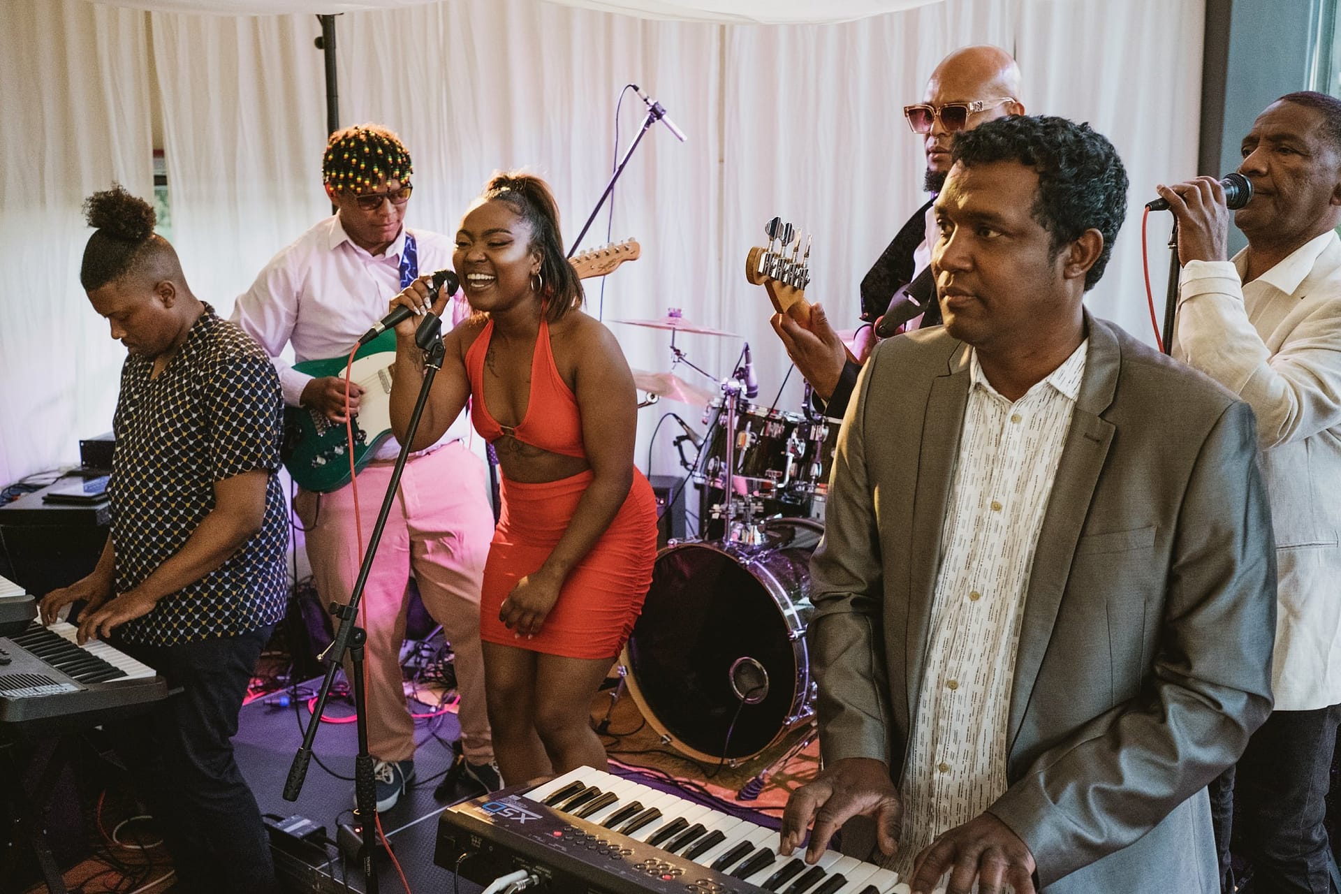 Greenwich Yacht Club Wedding Photography capturing a group of people playing keyboards at a wedding.