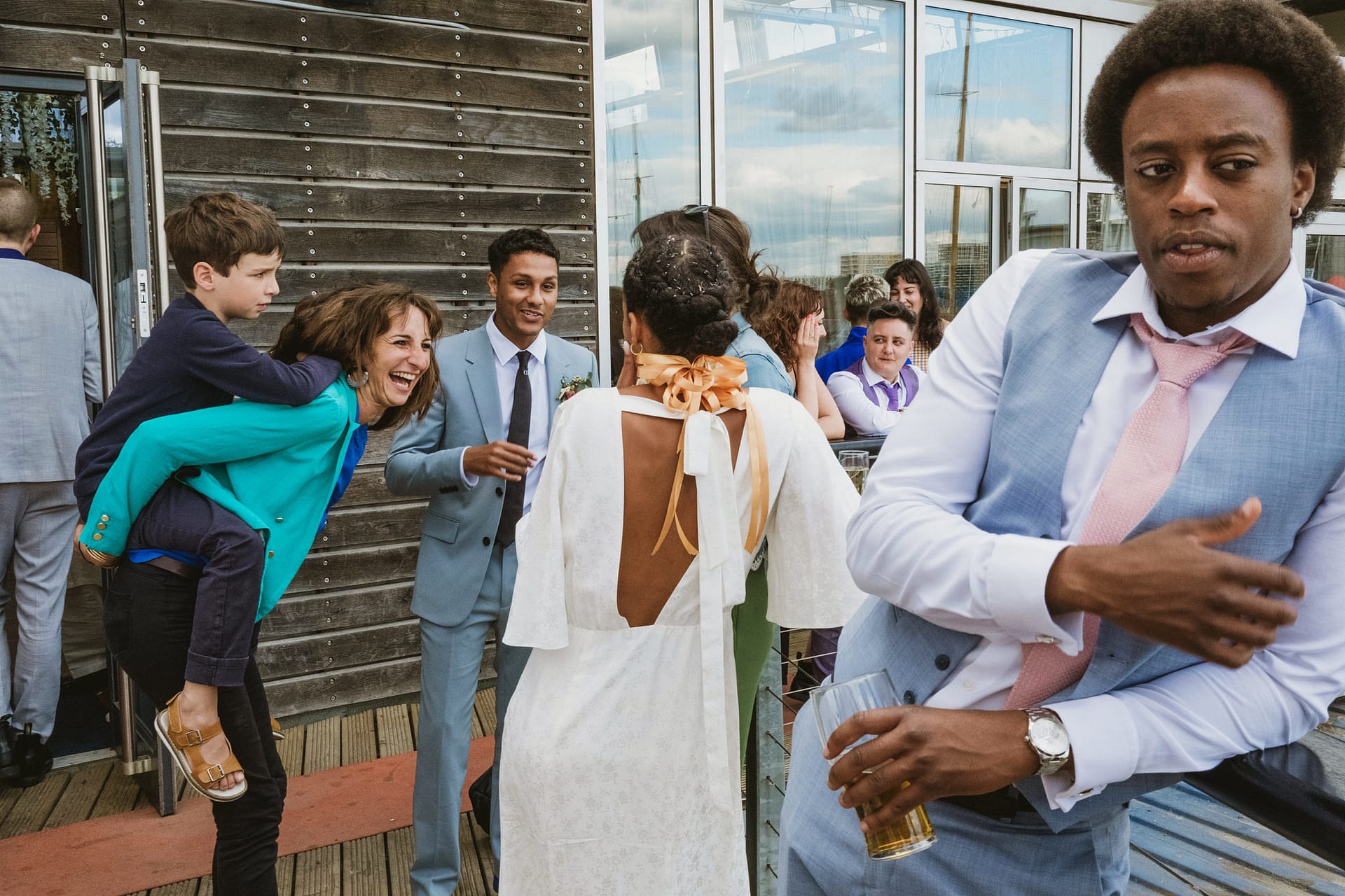 Greenwich Yacht Club Wedding Photography captures the joyful moments of a group of people celebrating at a wedding party.